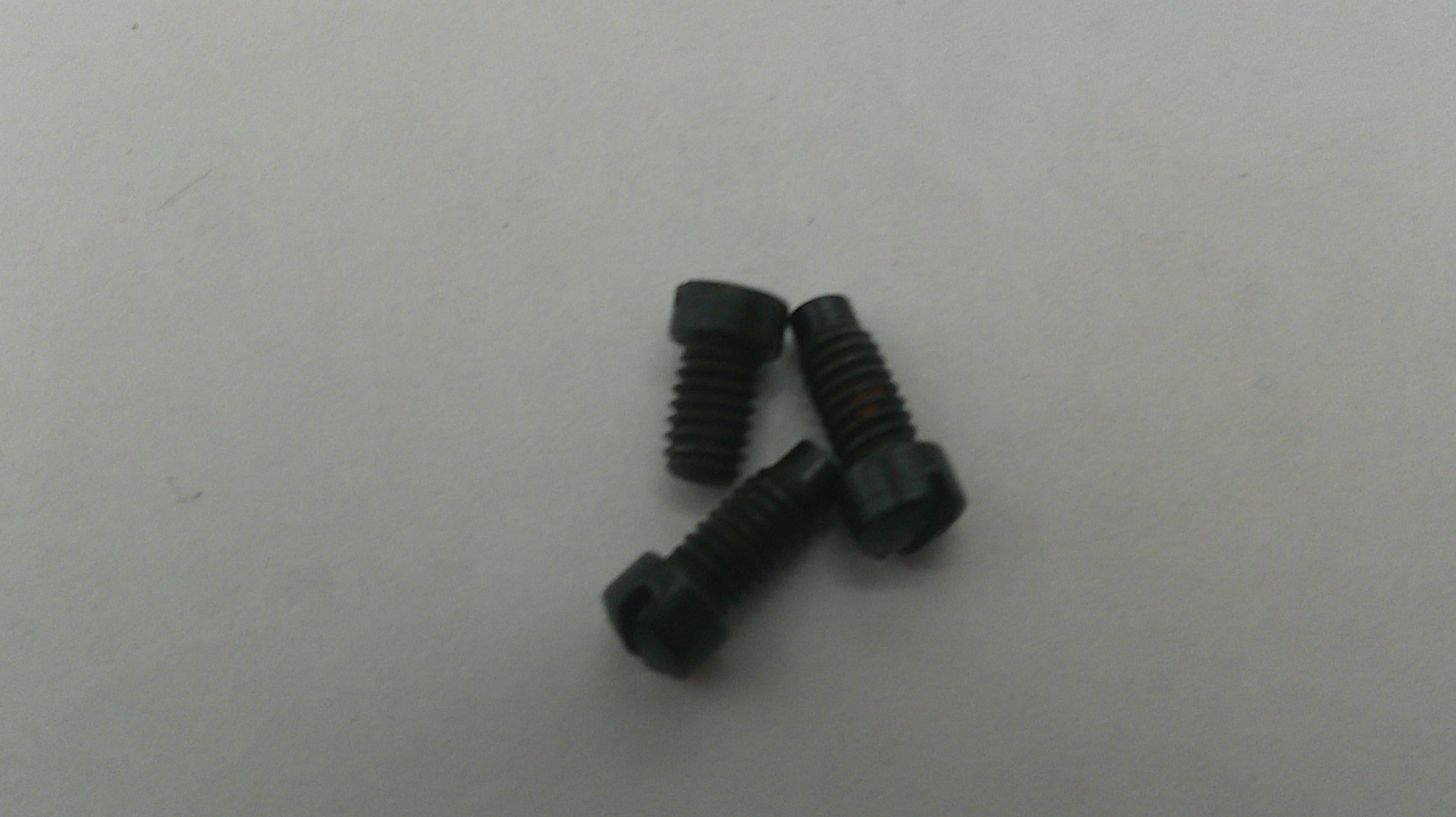 Two black screws on a light gray background