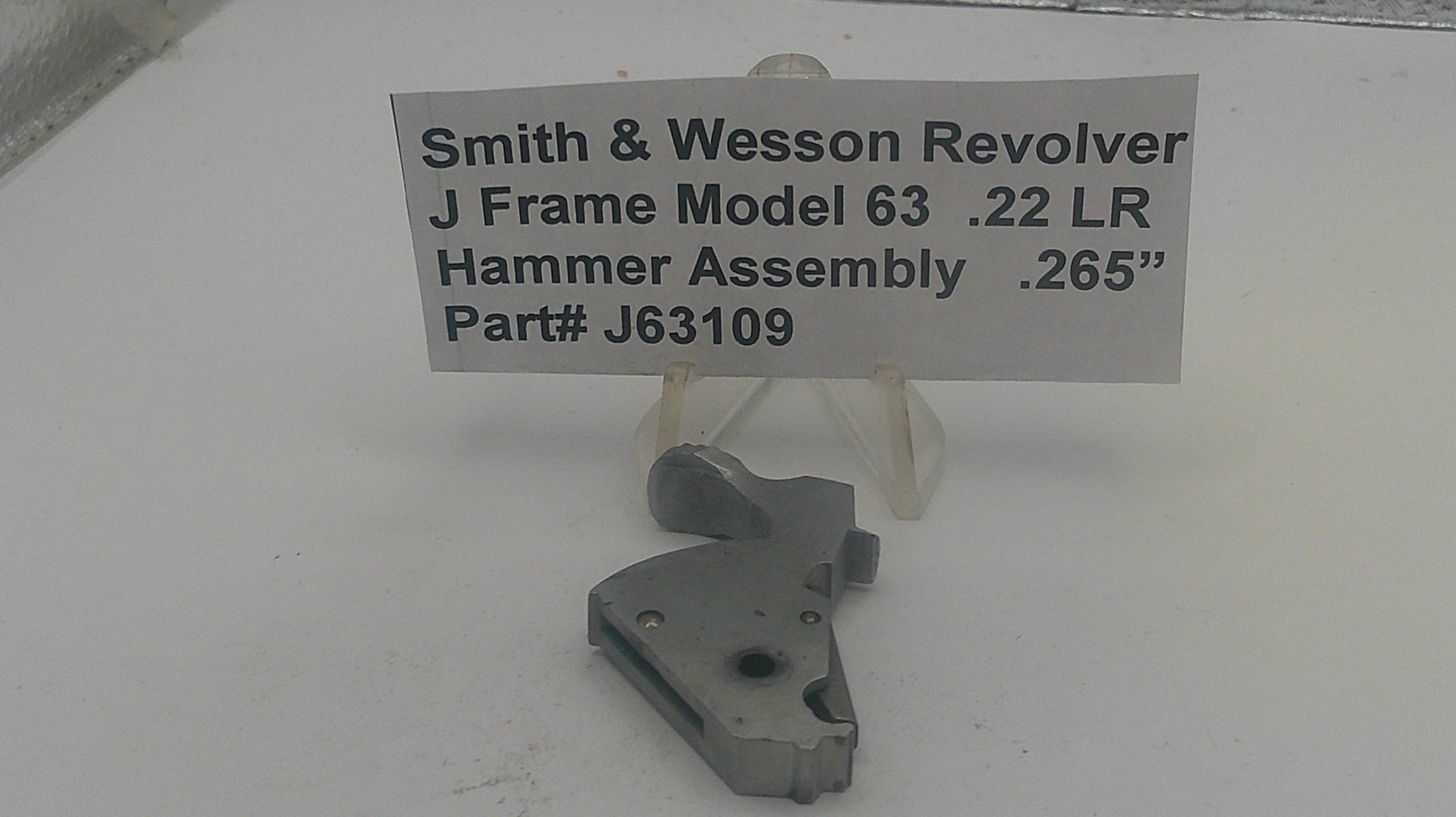 Smith & Wesson revolver hammer assembly with a label on a white background