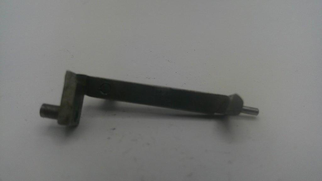 A small metal mechanical part with a bent shaft, flat mounting plate, and protruding pins, shown on a plain light background.