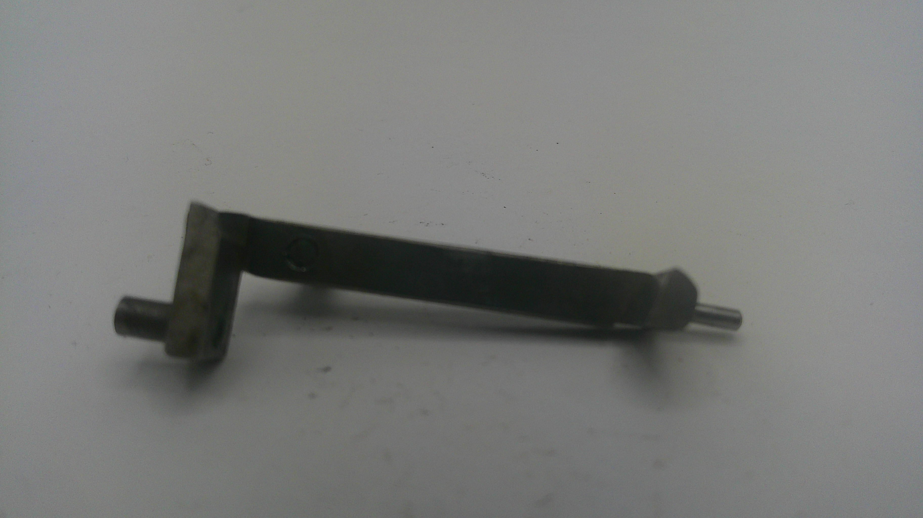 A small metal mechanical part with a bent shaft, flat mounting plate, and protruding pins, shown on a plain light background.