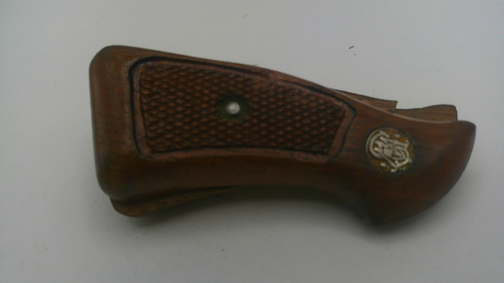 Brown leather gun holster with textured surface on a white background
