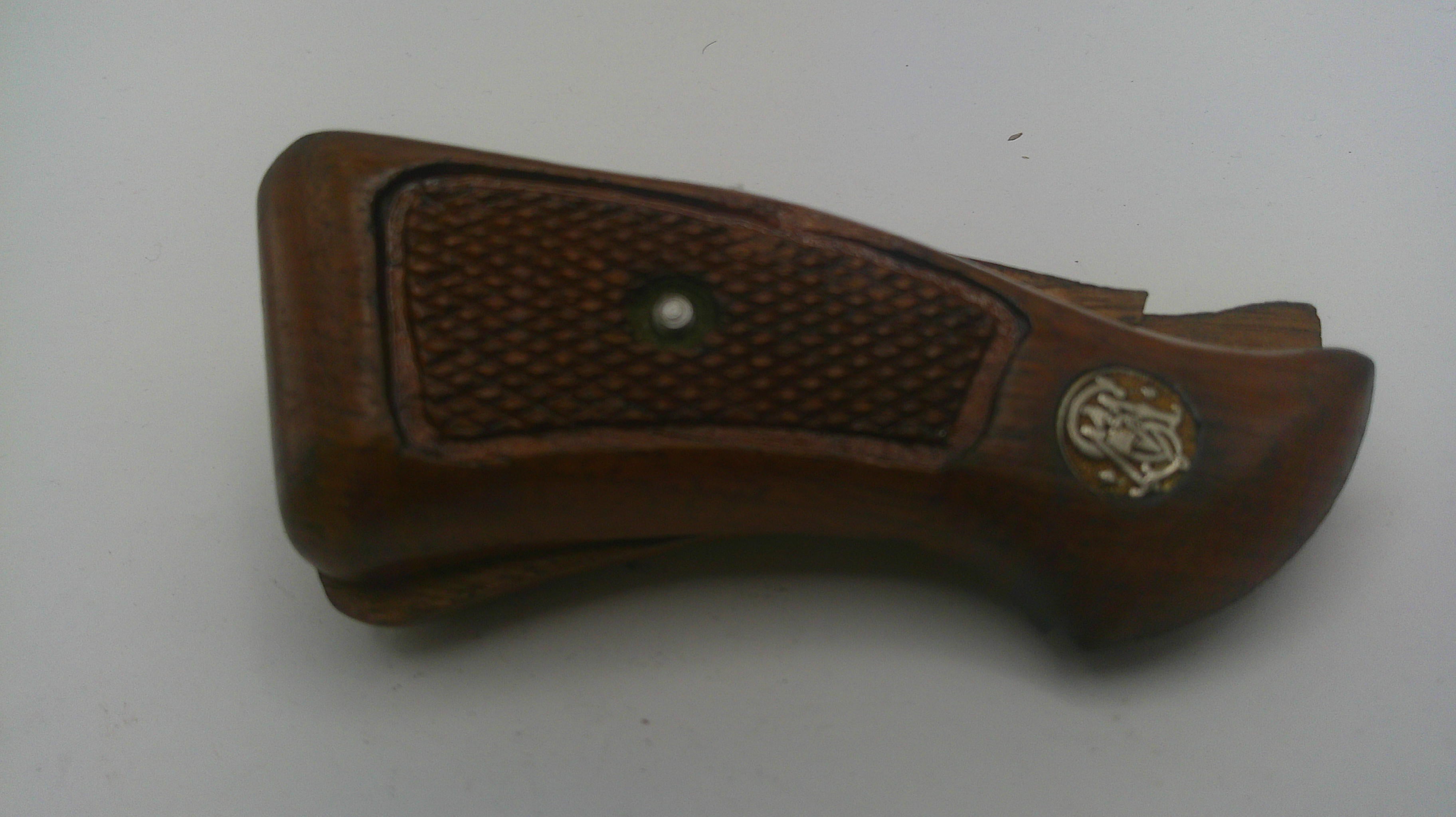 Brown leather gun holster with textured surface on a white background