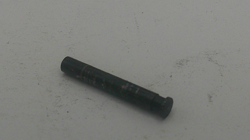 Black cylindrical object on a light gray background