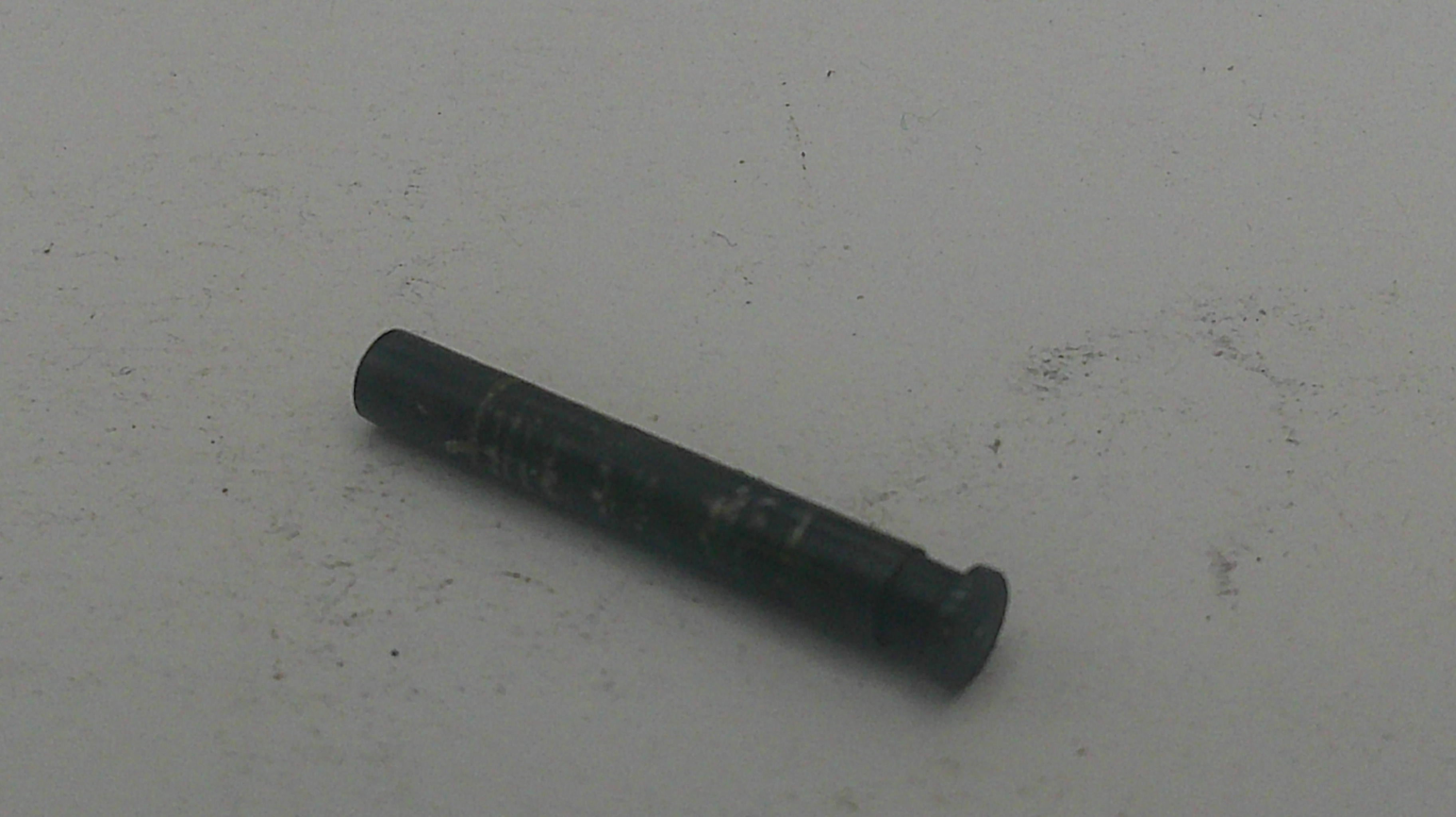 Black cylindrical object on a light gray background