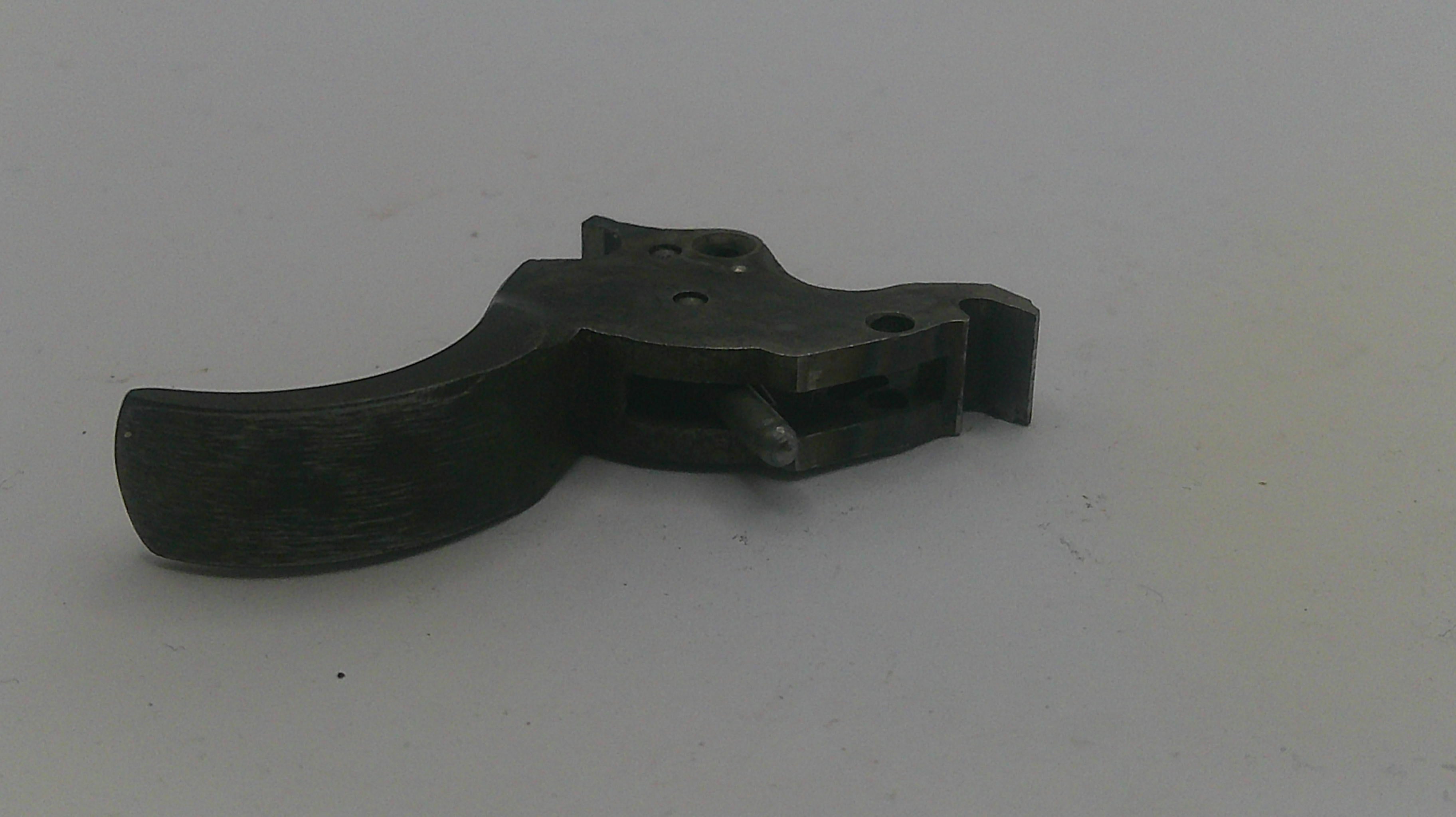 Black metal gun trigger on a white background