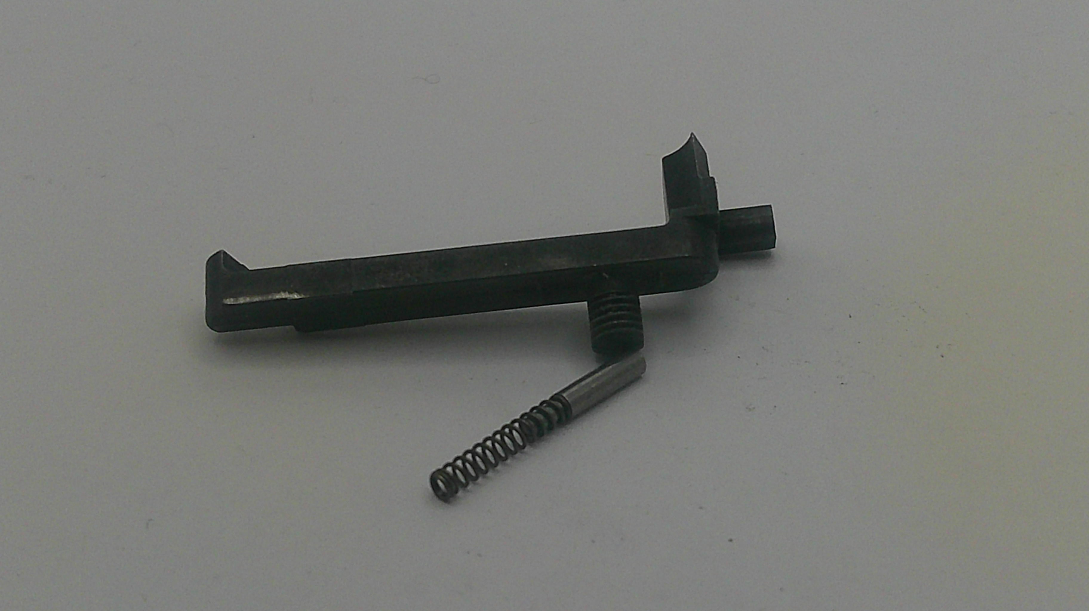 Metal gun part with a spring on a white background