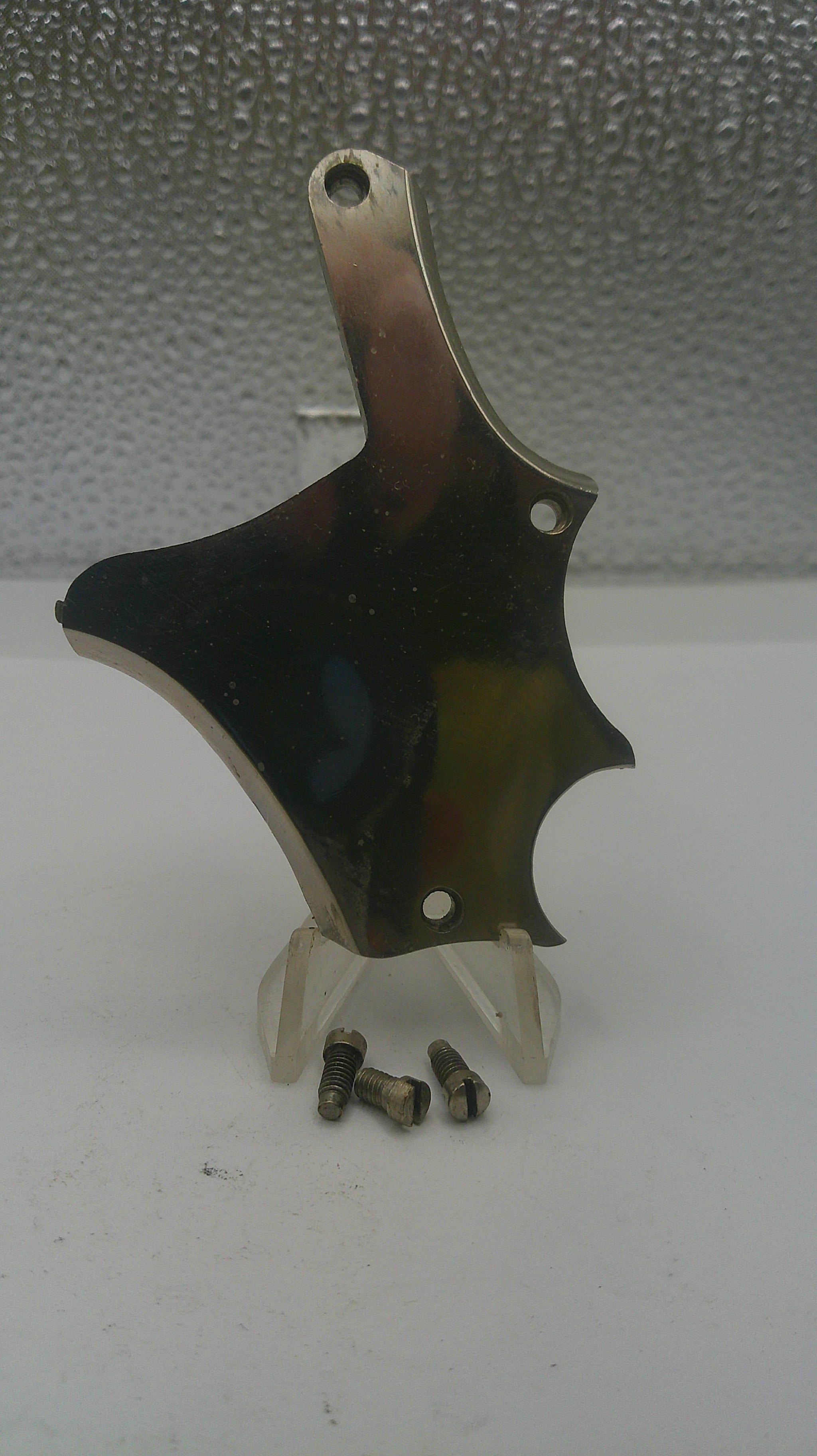 Violin bridge with saddle on a textured surface