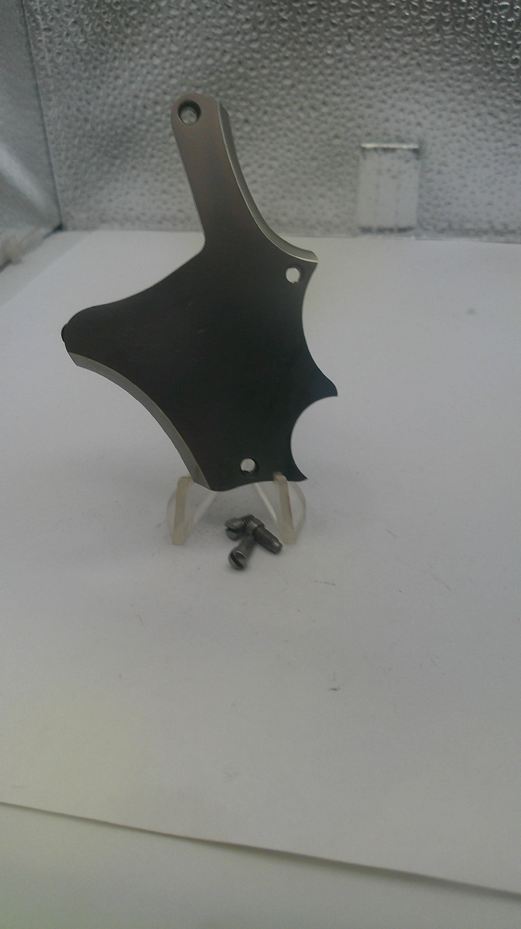 Black and silver tool on a textured white surface
