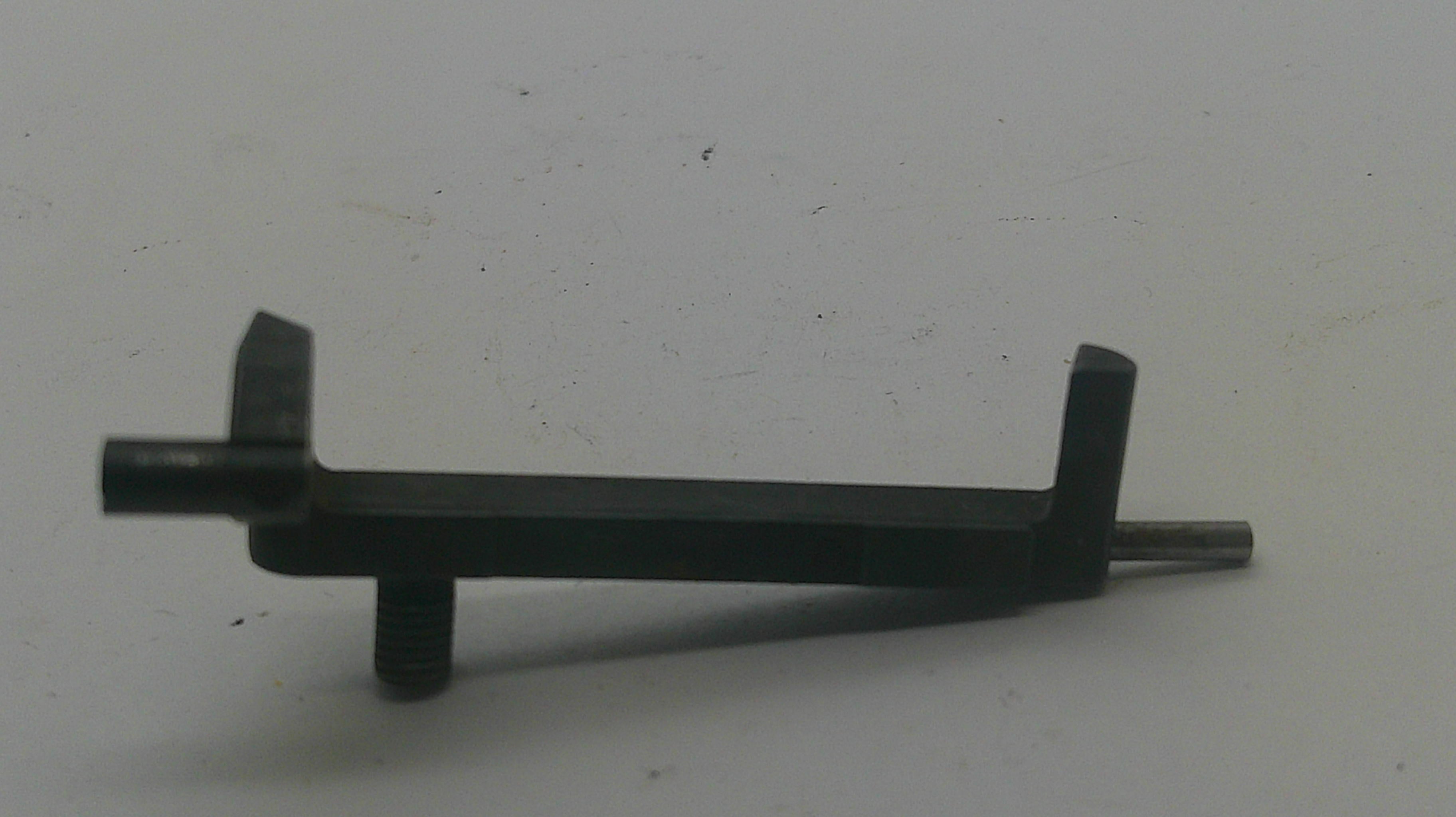 A small black metal hardware component with a flat rectangular body, two angled tabs, and a threaded rod extending from one end, photographed on a plain light background.