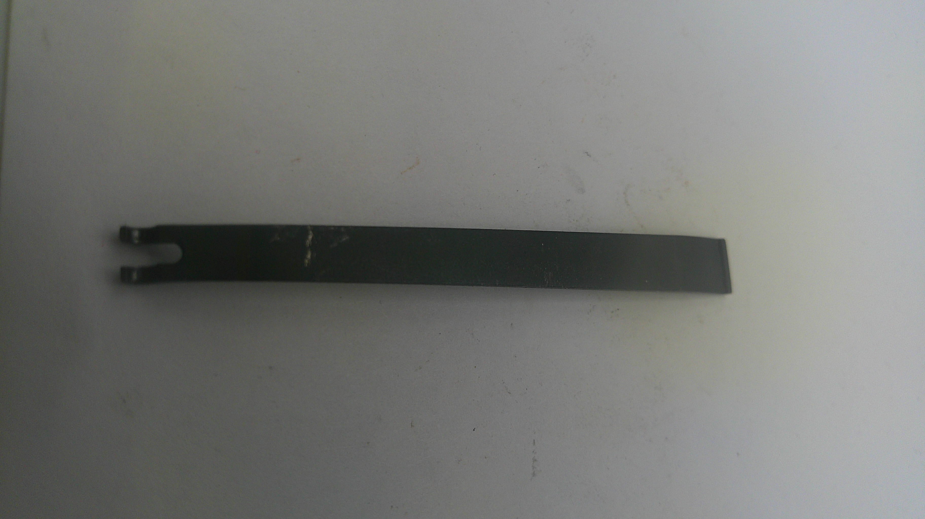 Long black metal tool on a white background