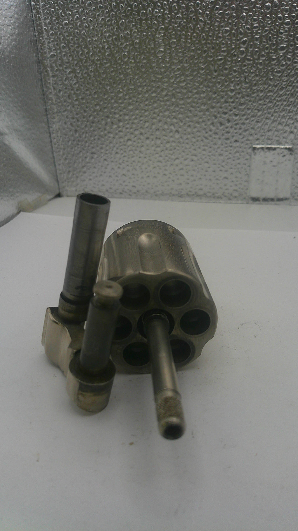 Metallic revolver on a textured surface