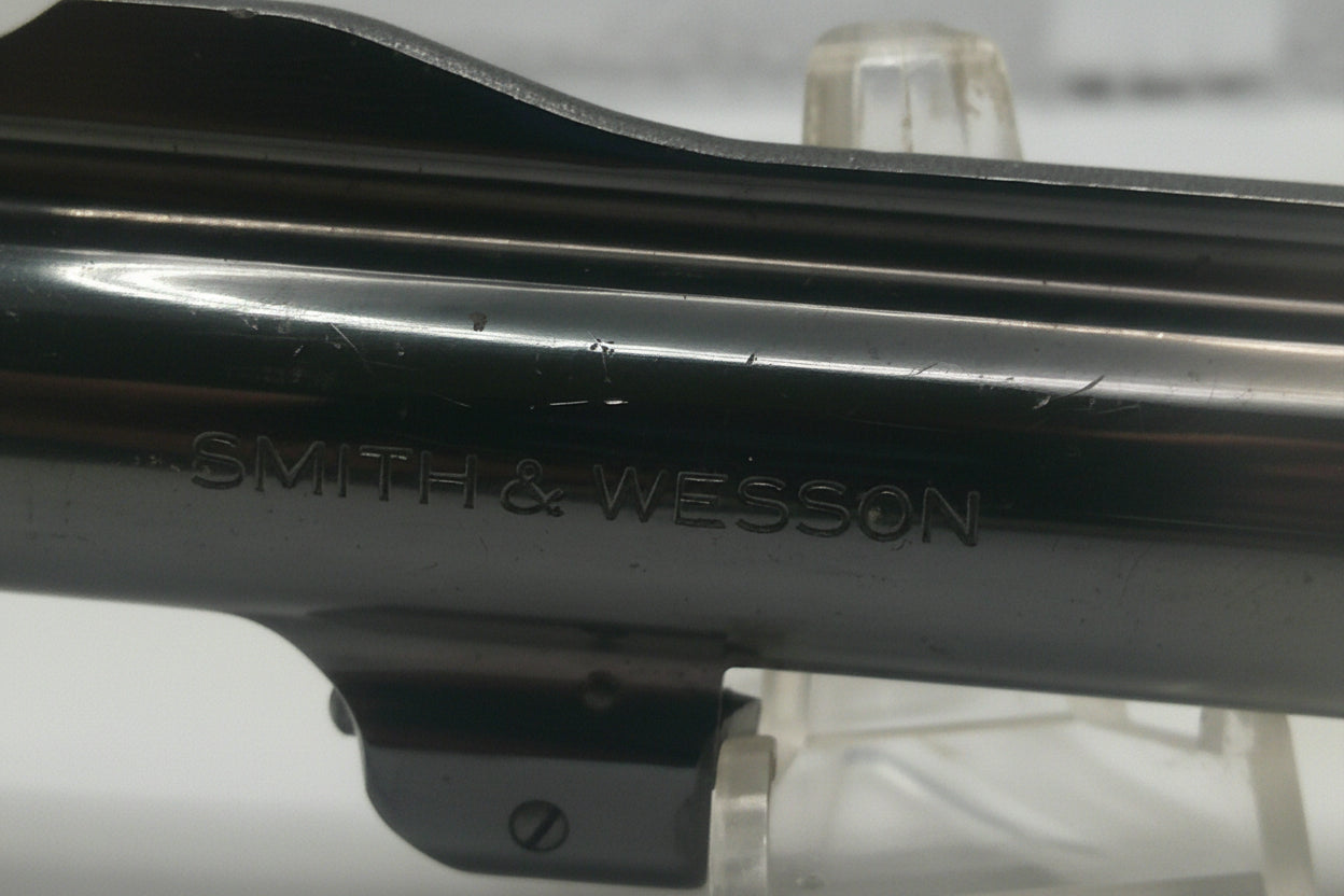 Close-up of a Smith & Wesson firearm slide on a white background