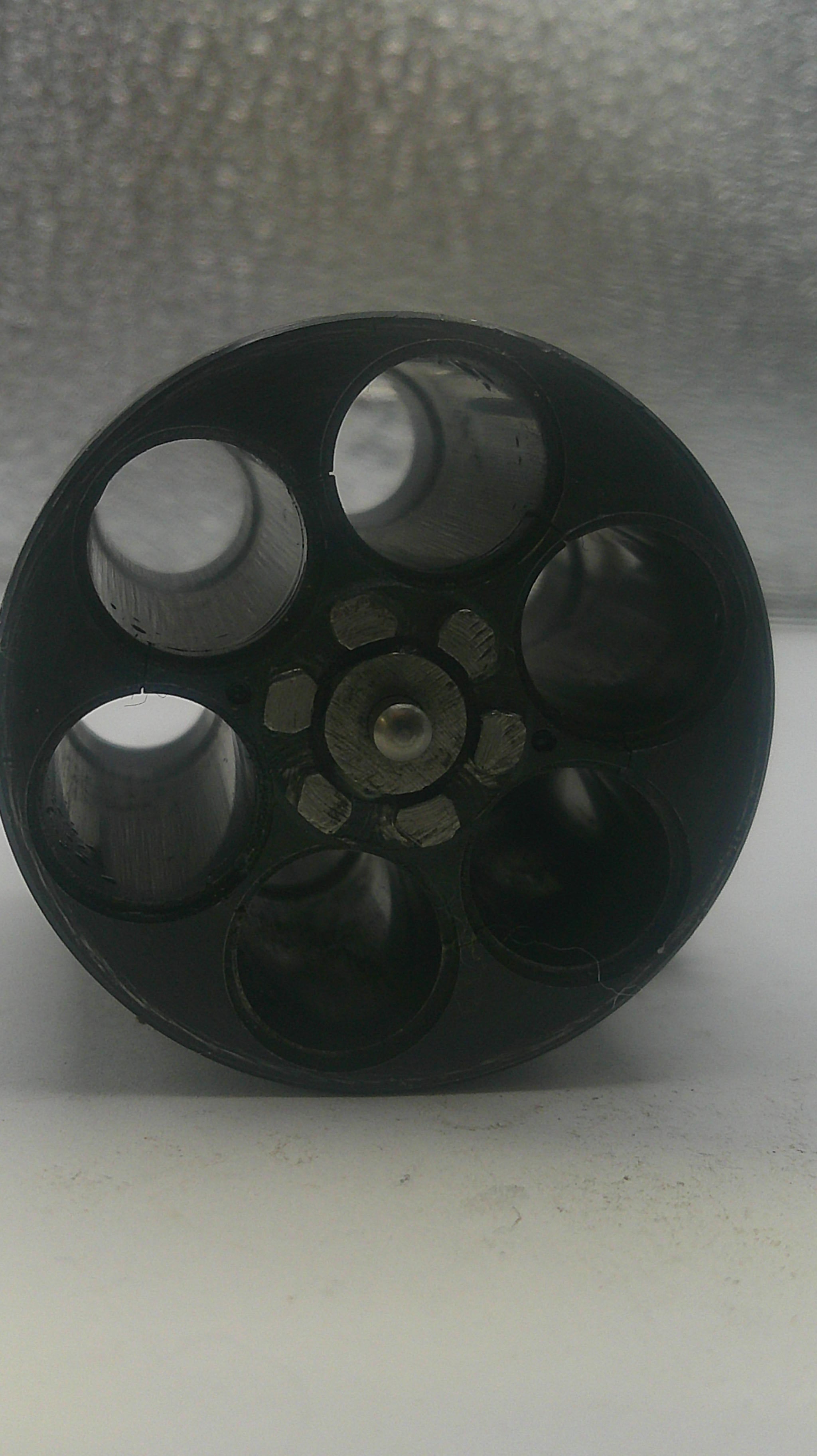 Black wheel or pulley system on a white background