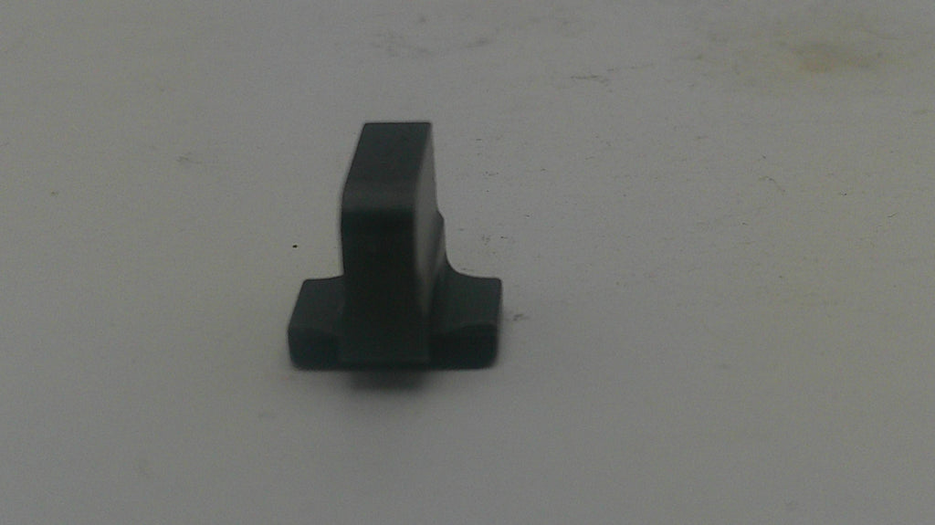 A small black plastic hardware component, possibly a latch stopper or mounting tab, shown on a plain light gray surface.