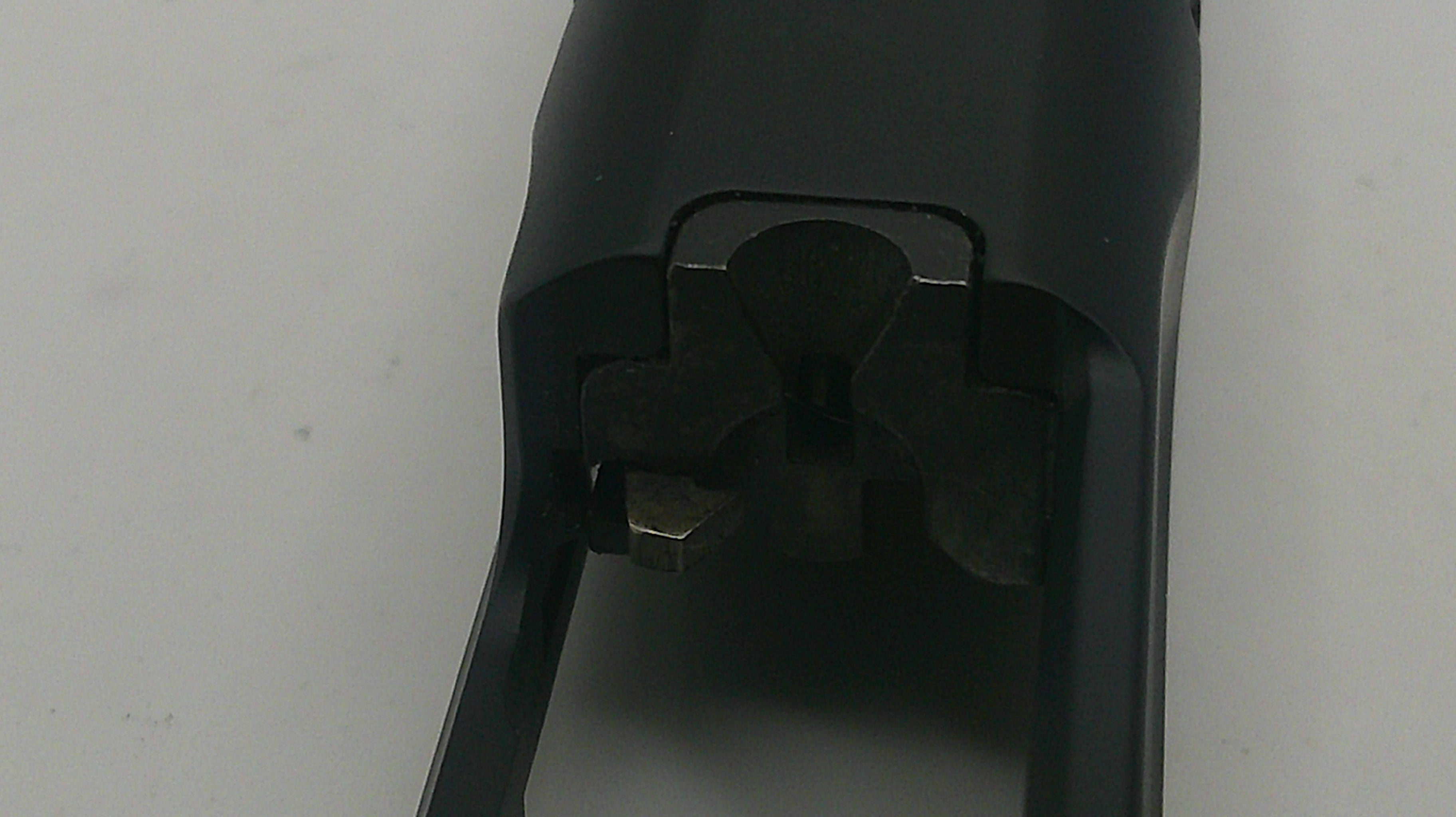 Close-up of a black mechanical component on a light gray background