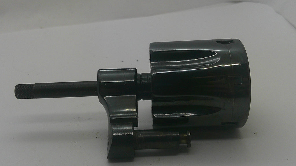 A black metal mechanical component with a cylindrical body, a protruding shaft, and a small attached rod, photographed on a plain light background.
