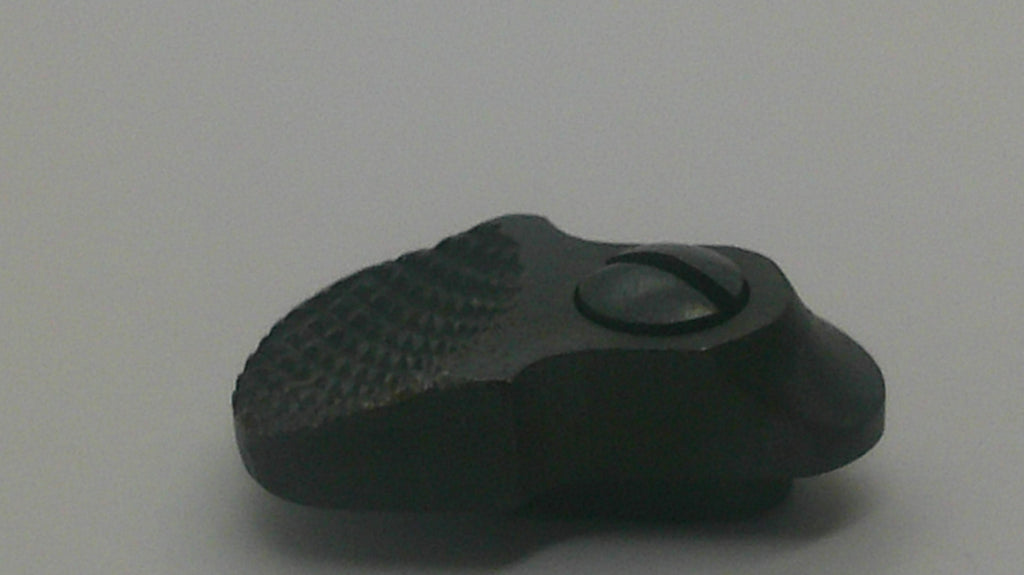 A small black plastic or rubber knob with a textured surface and a circular cutout, photographed on a plain light gray background.