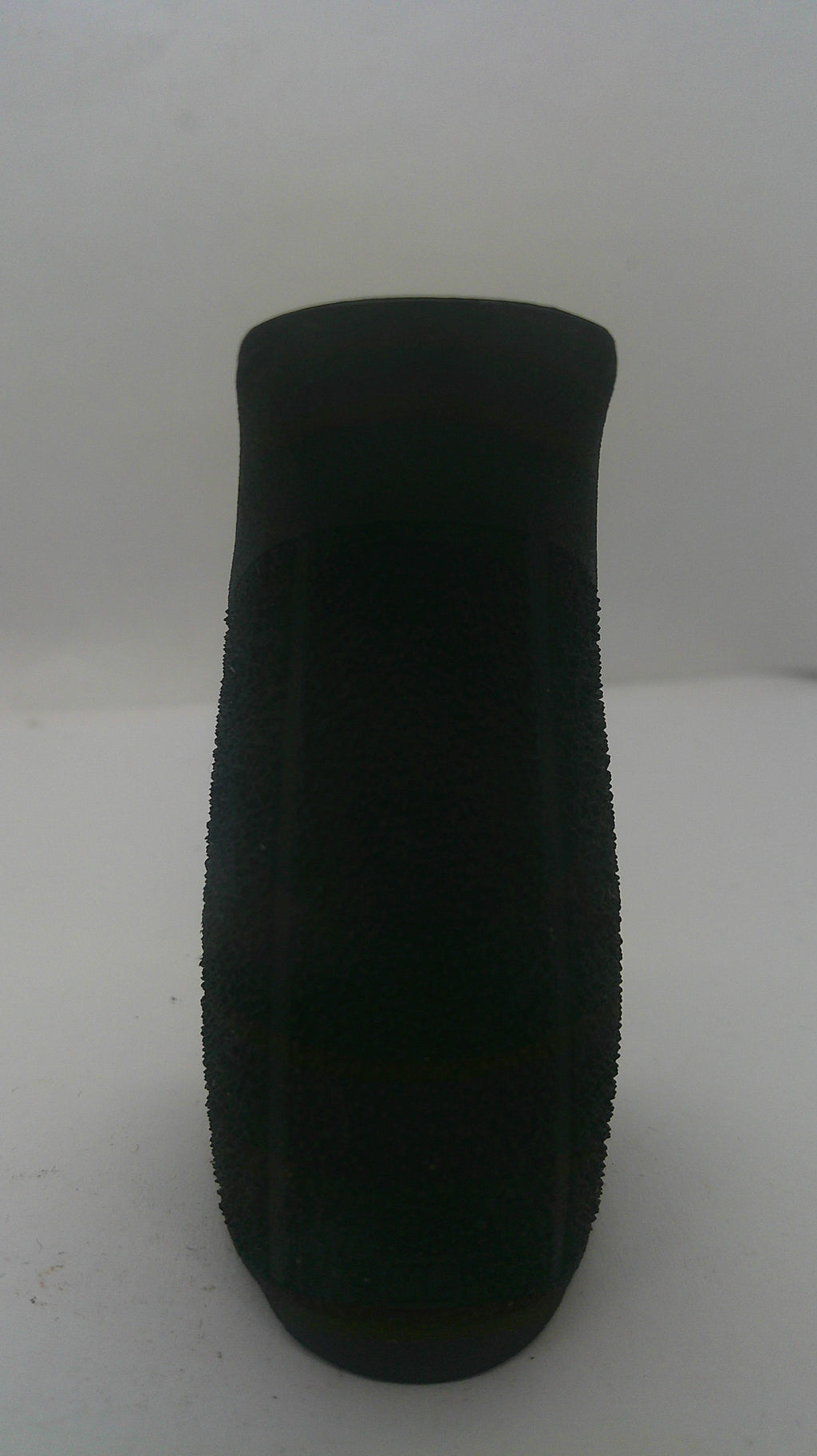 A black textured foam or sponge grip pad shown from a top-down view on a plain light background.