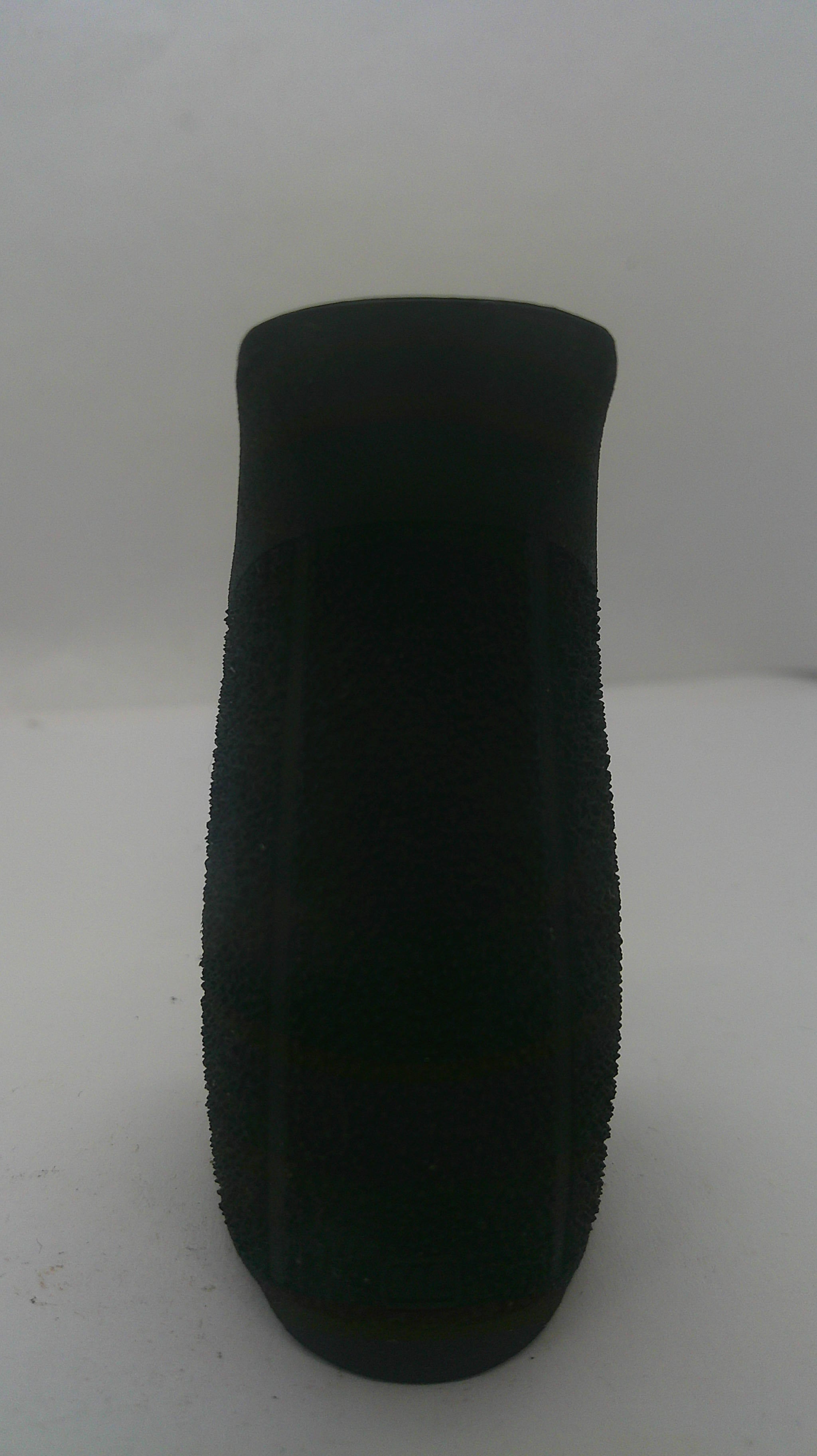 A black textured foam or sponge grip pad shown from a top-down view on a plain light background.