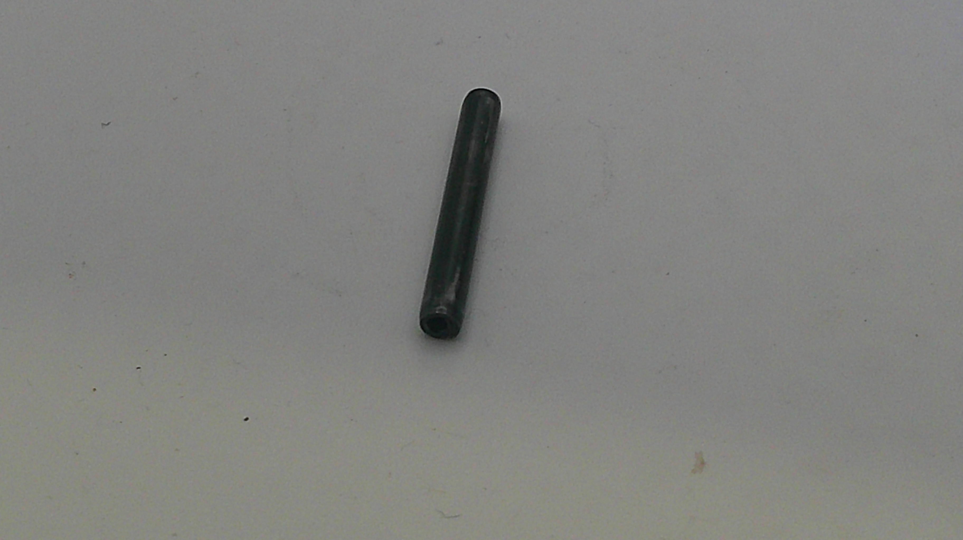 Black cylindrical object on a white background