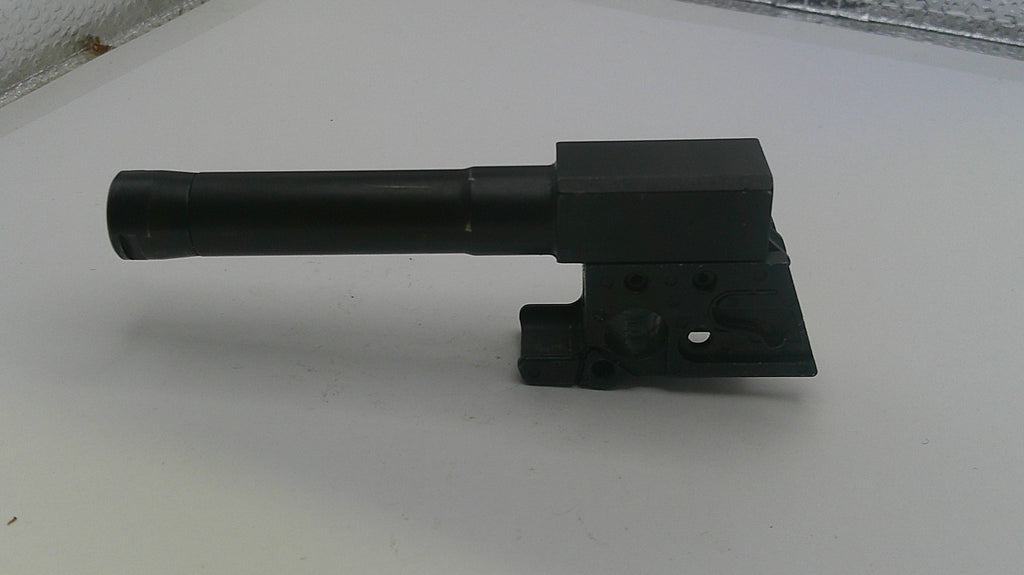 Black metal tool or component on a white surface
