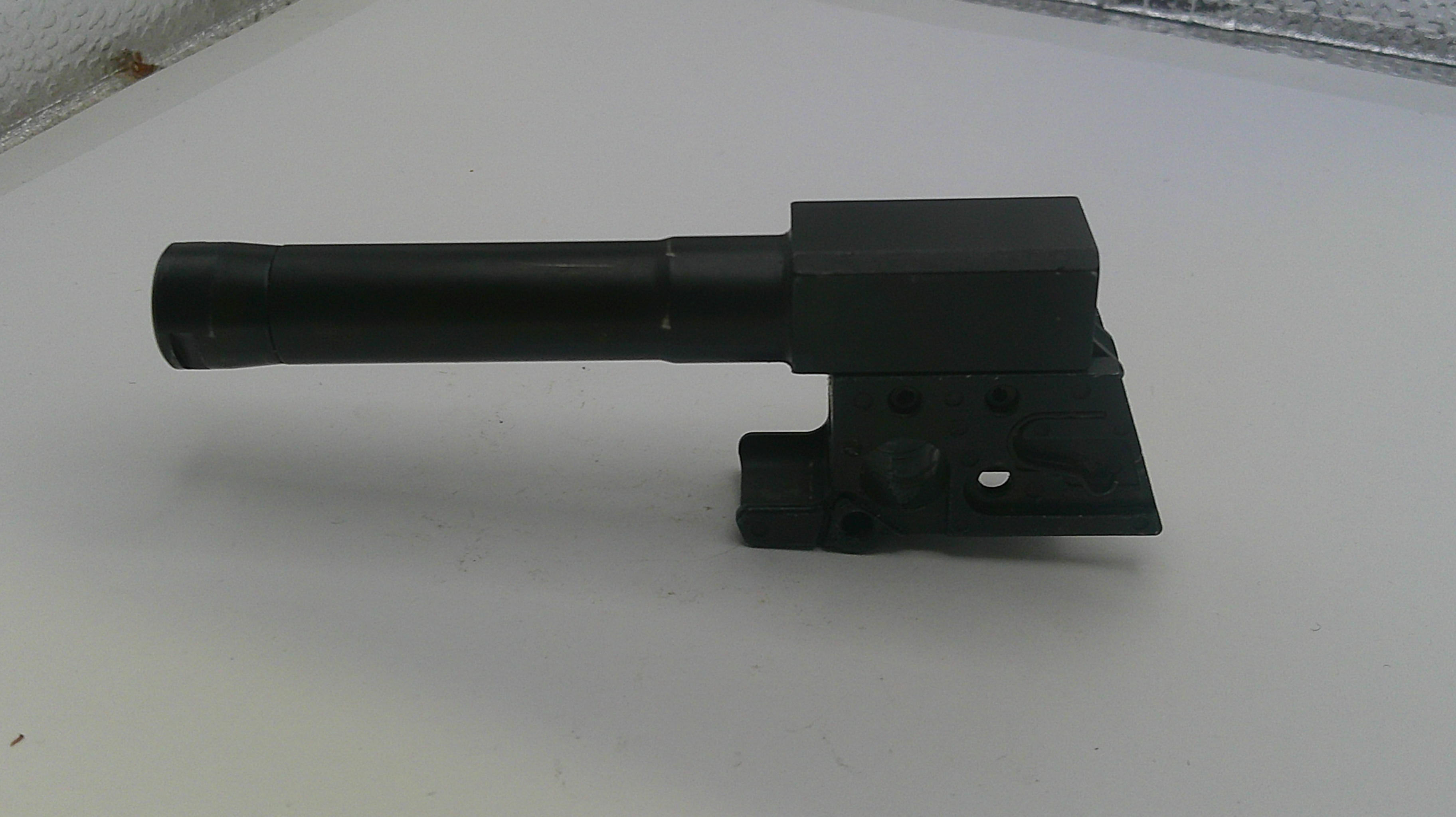 Black metal tool or component on a white surface