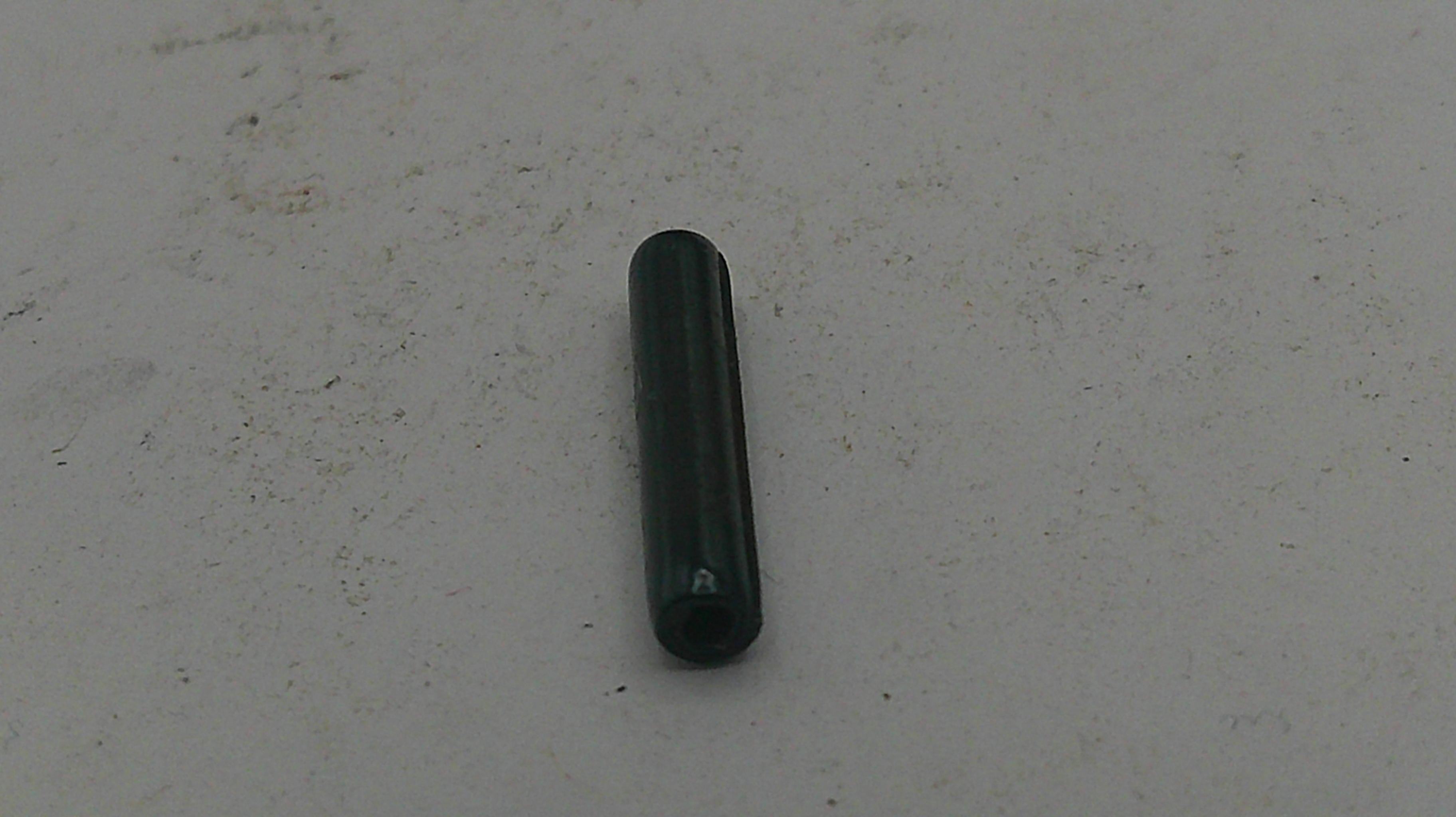 Black cylindrical object on a light gray background