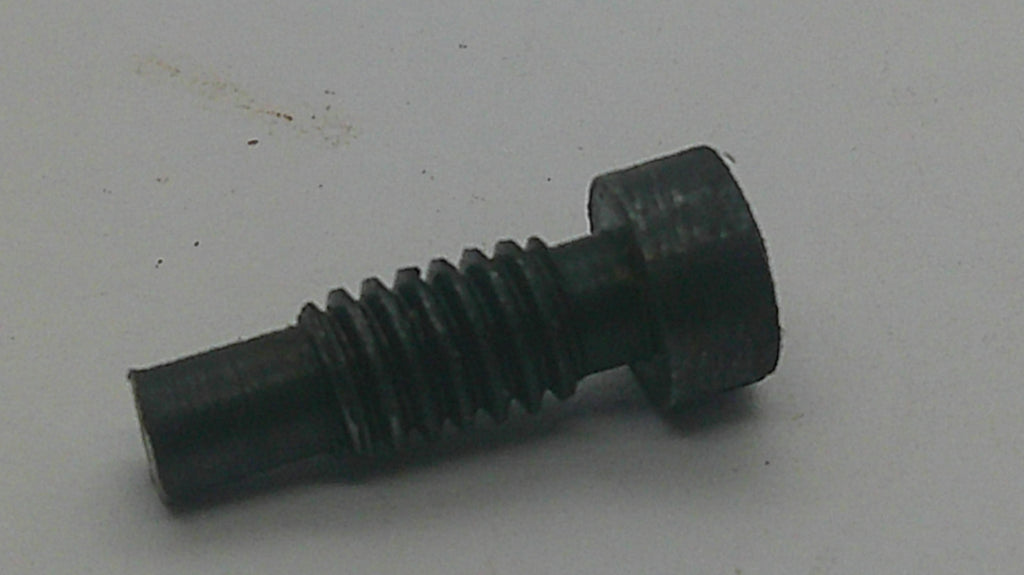 A small black metal threaded screw or bolt with a hexagonal head, photographed on a plain light gray surface.