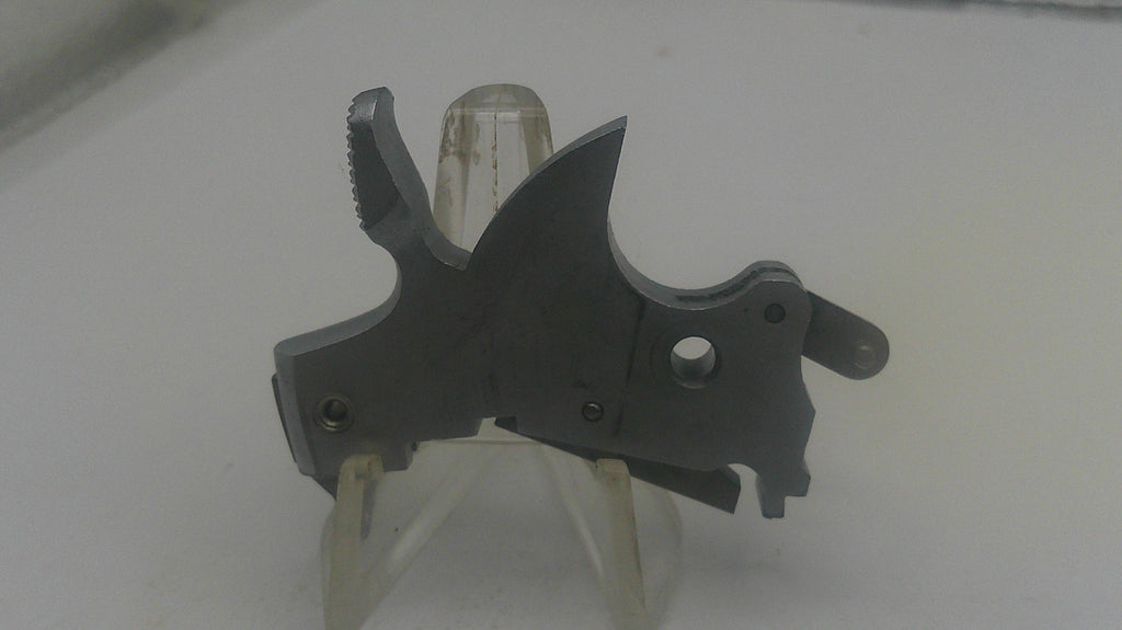 Black metal tool on a white stand with a blurred background