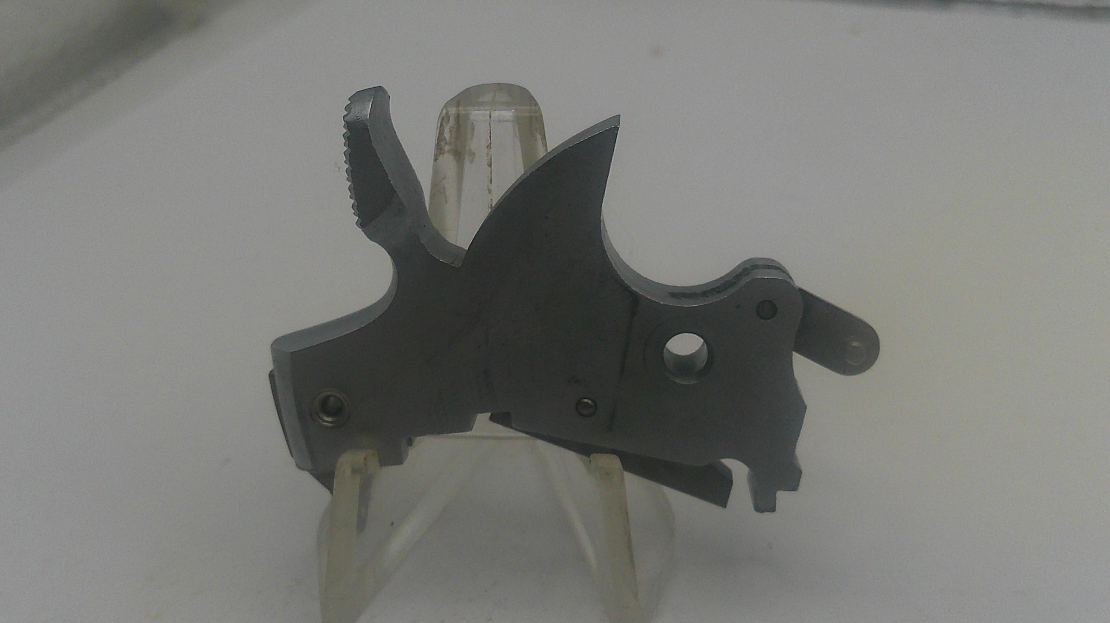 Black metal tool on a white stand with a blurred background