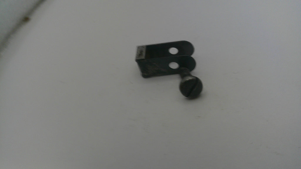 Small metal bracket on a white surface