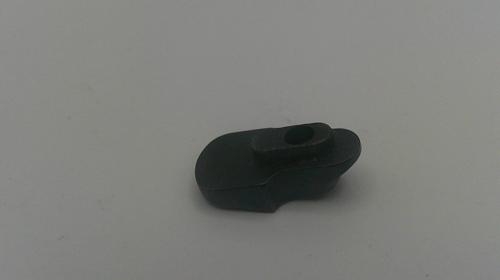 A small black plastic or rubber component with a curved, looped shape and a central hole, photographed on a plain light gray background.