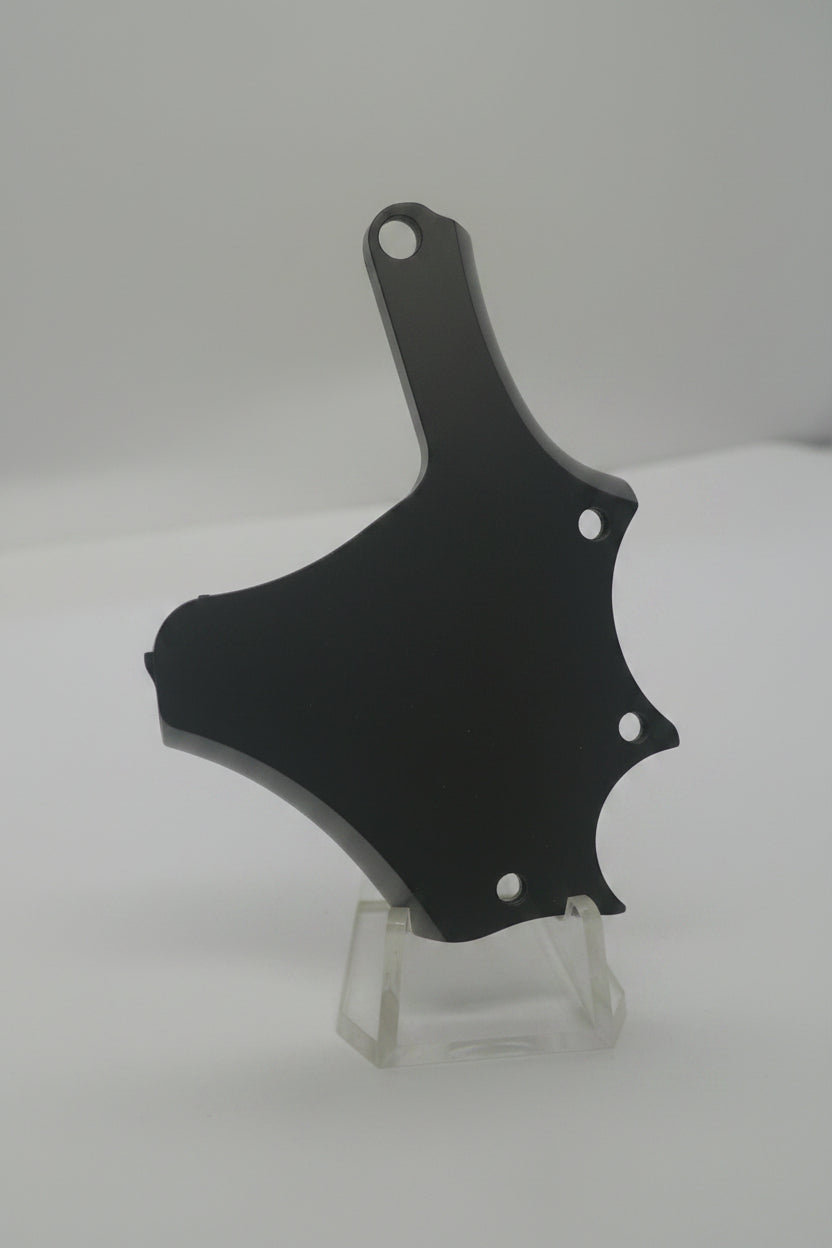 A black metal wall hook with a curved hook arm and two mounting holes, shown mounted on a plain light-colored wall.