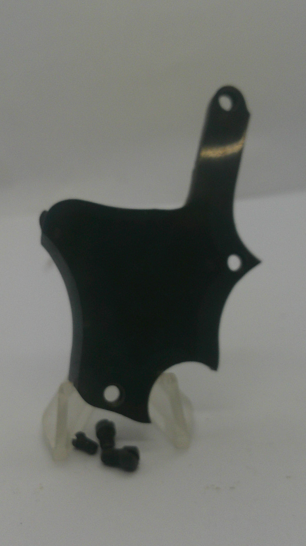 A black metal mounting bracket with pre-drilled holes, shown with two small black screws and a clear plastic protective cover on a plain white background.