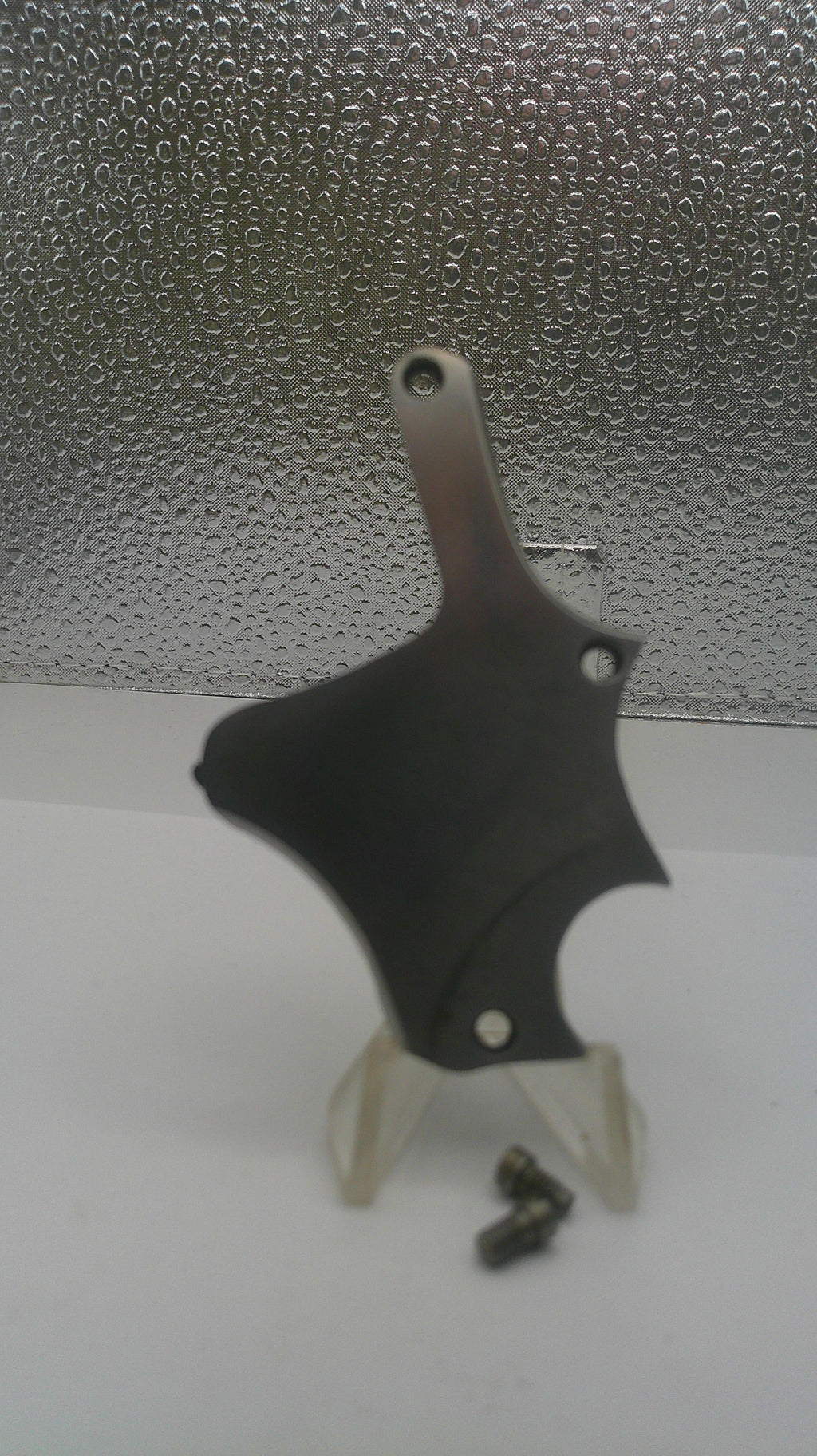 Black motorcycle fairing on a textured surface