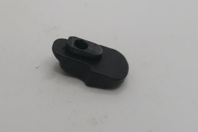 Small black object on a white surface