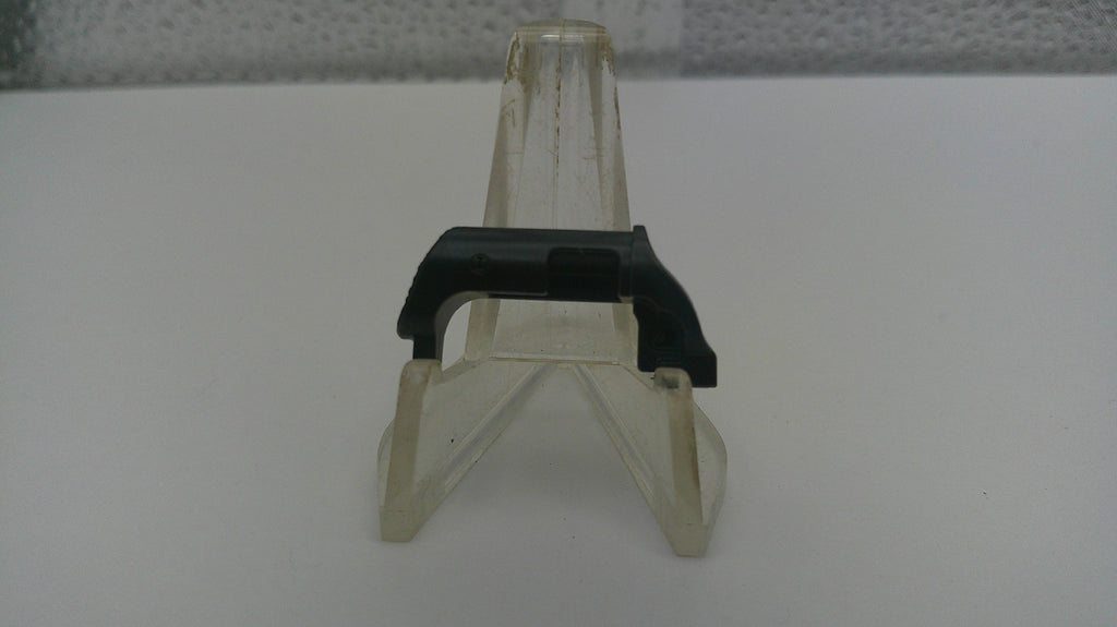 Small clear plastic stand with black base on a white surface