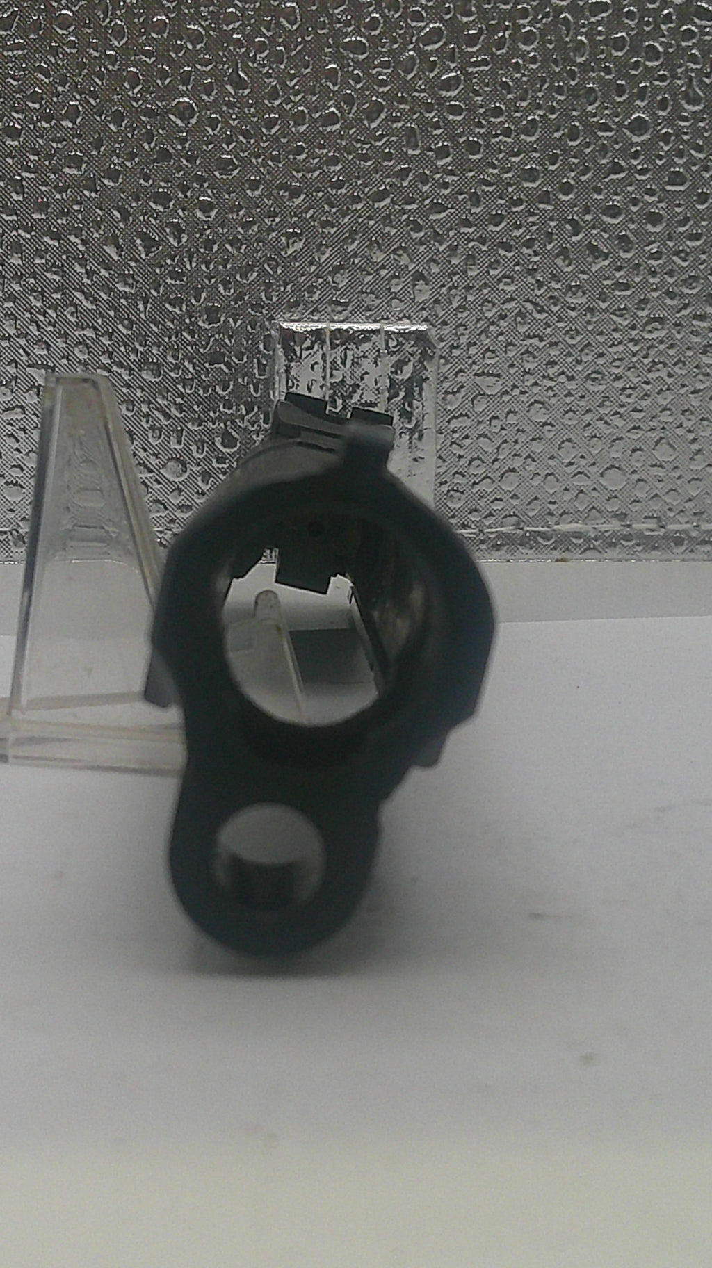 Black metal bracket on a textured white wall