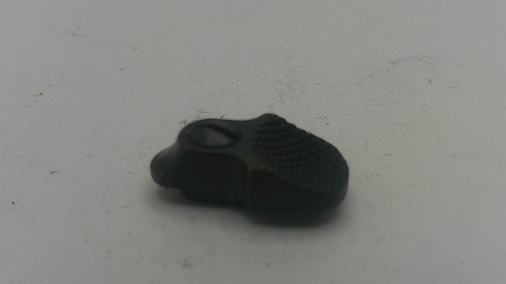 Black rubber duck on a white textured surface
