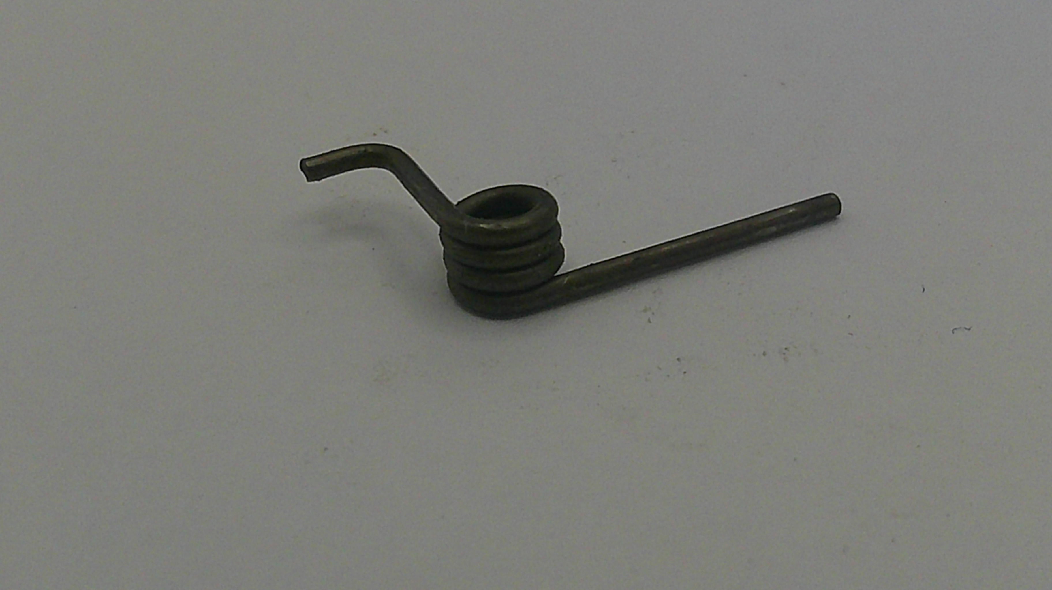 Metallic coil spring on a gray background