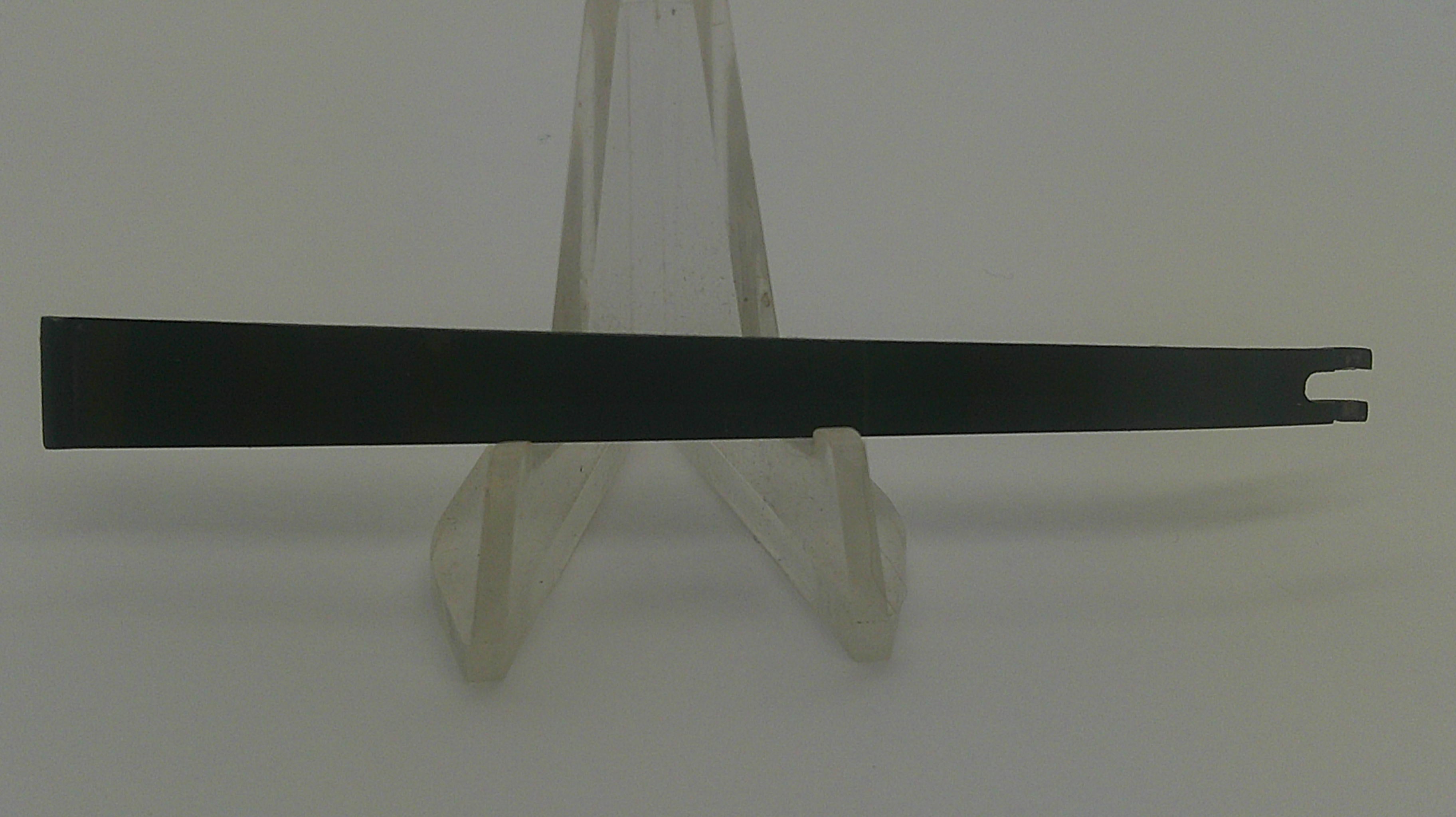 A long, narrow black metal pry bar or tool with a split tip, displayed horizontally on a clear plastic stand against a plain light background.
