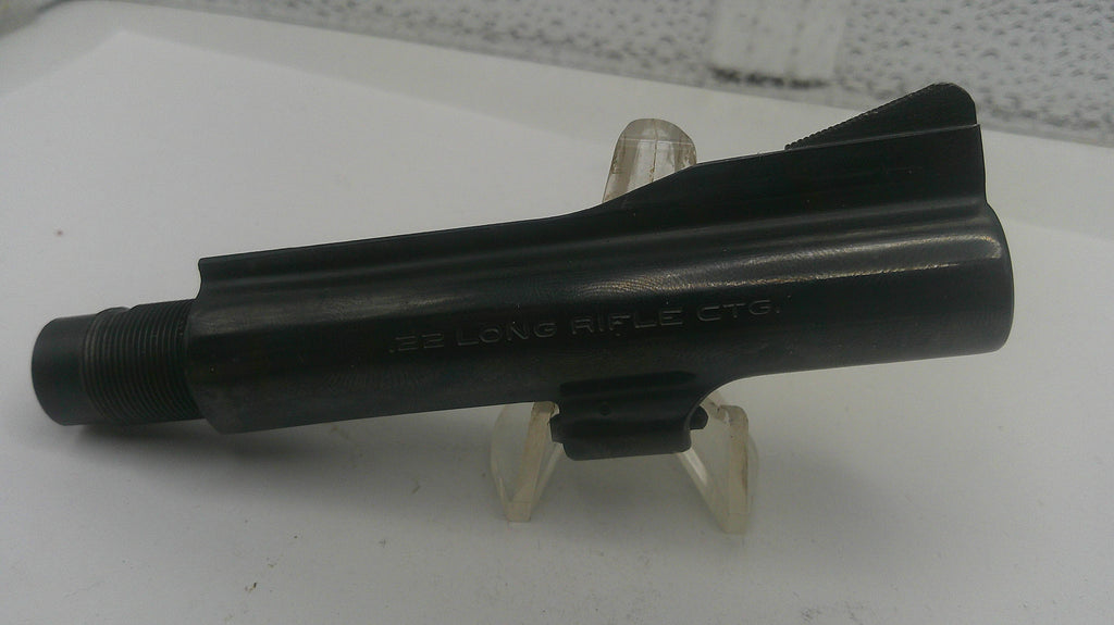 Black rifle stock on a white stand with a textured background