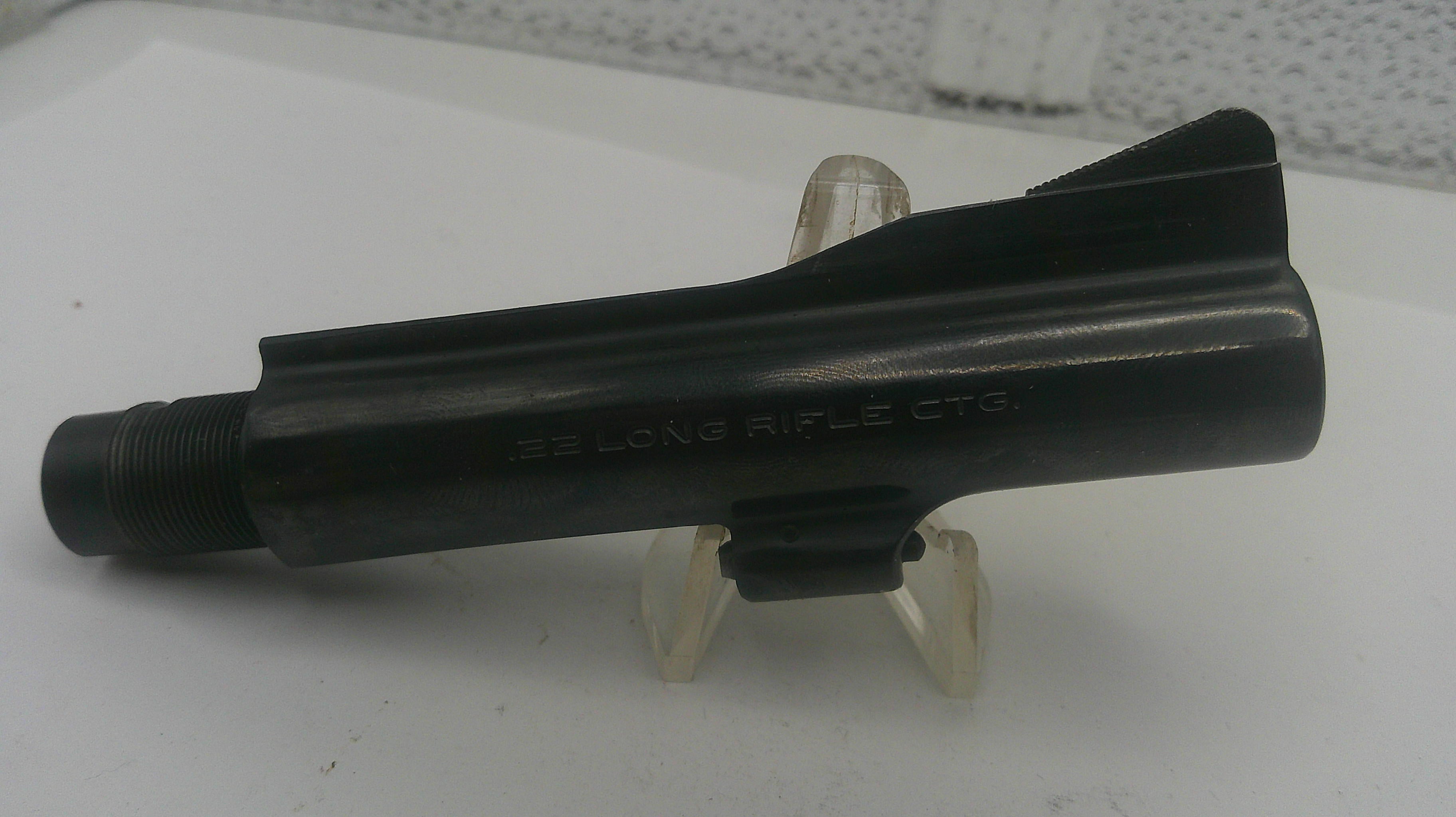 Black rifle stock on a white stand with a textured background