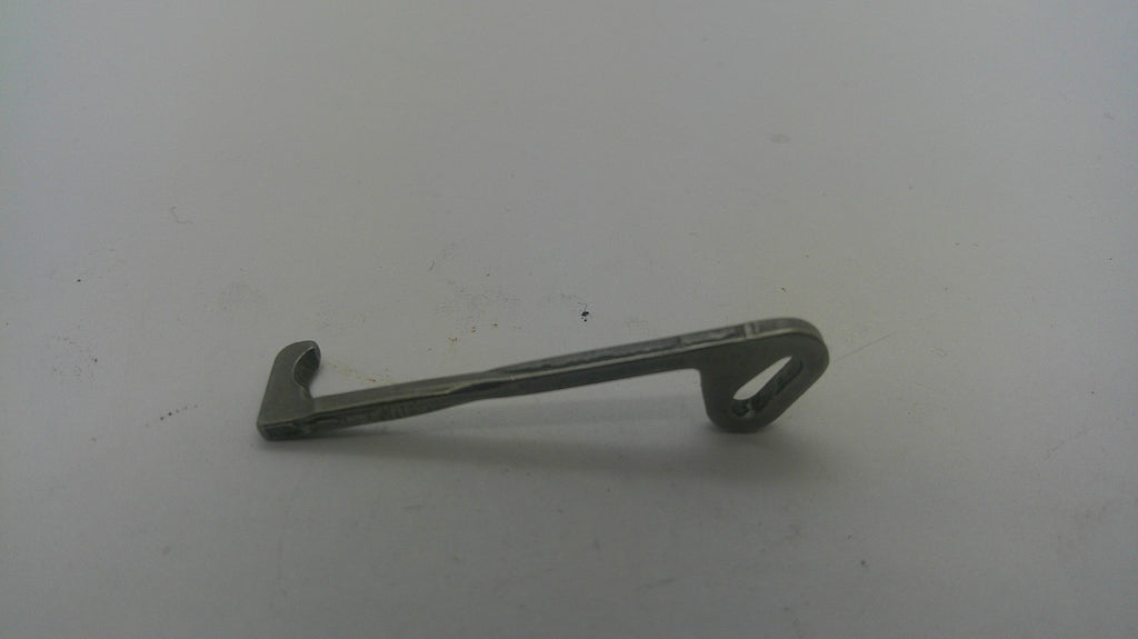 A small metal latch or bracket with a looped end, photographed on a plain light gray surface.