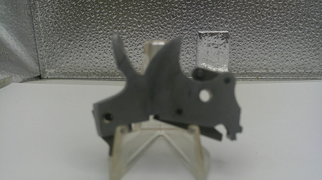 Metallic object on a stand against a textured silver background