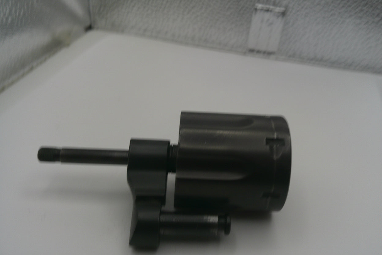Black mechanical component on a white surface with a textured background