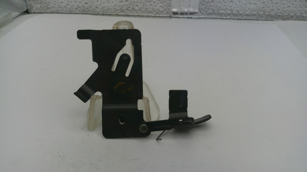 Black metal bracket on a white surface with a patterned background