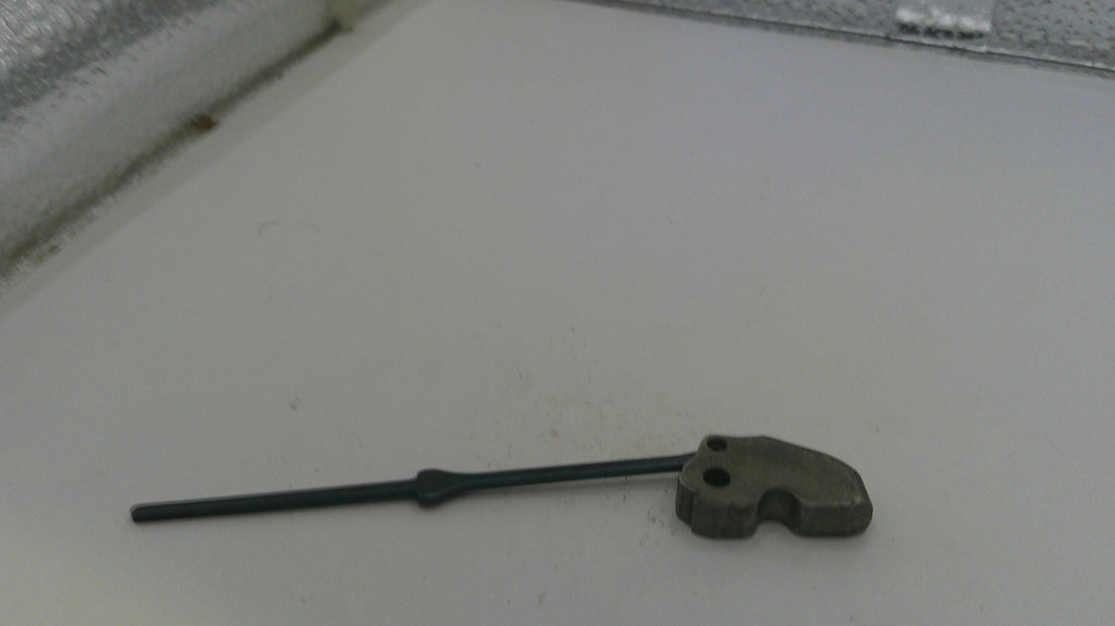 Small metal tool on a white surface