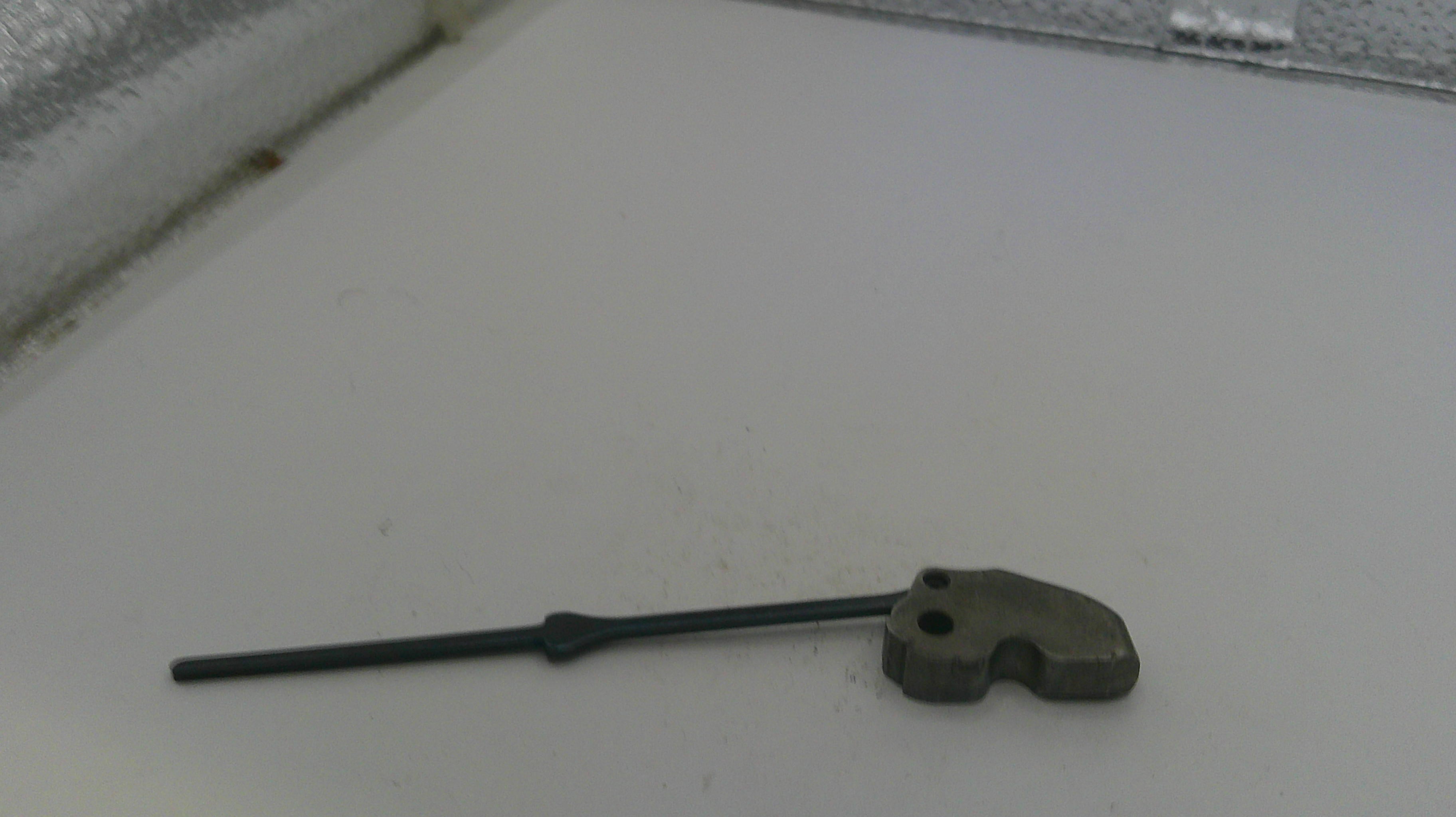 Small metal tool on a white surface