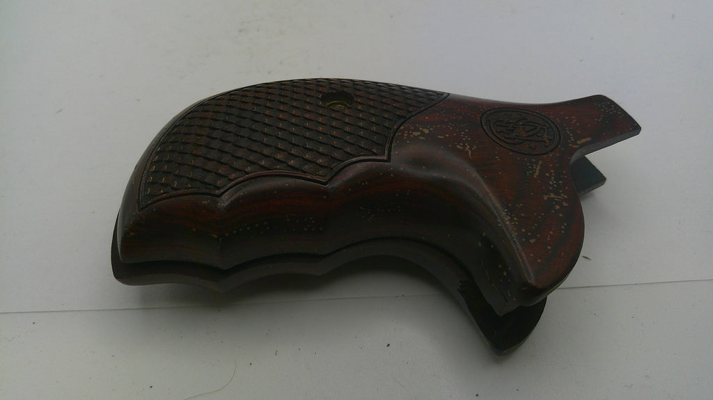 Wooden gun stock with intricate carvings on a white background